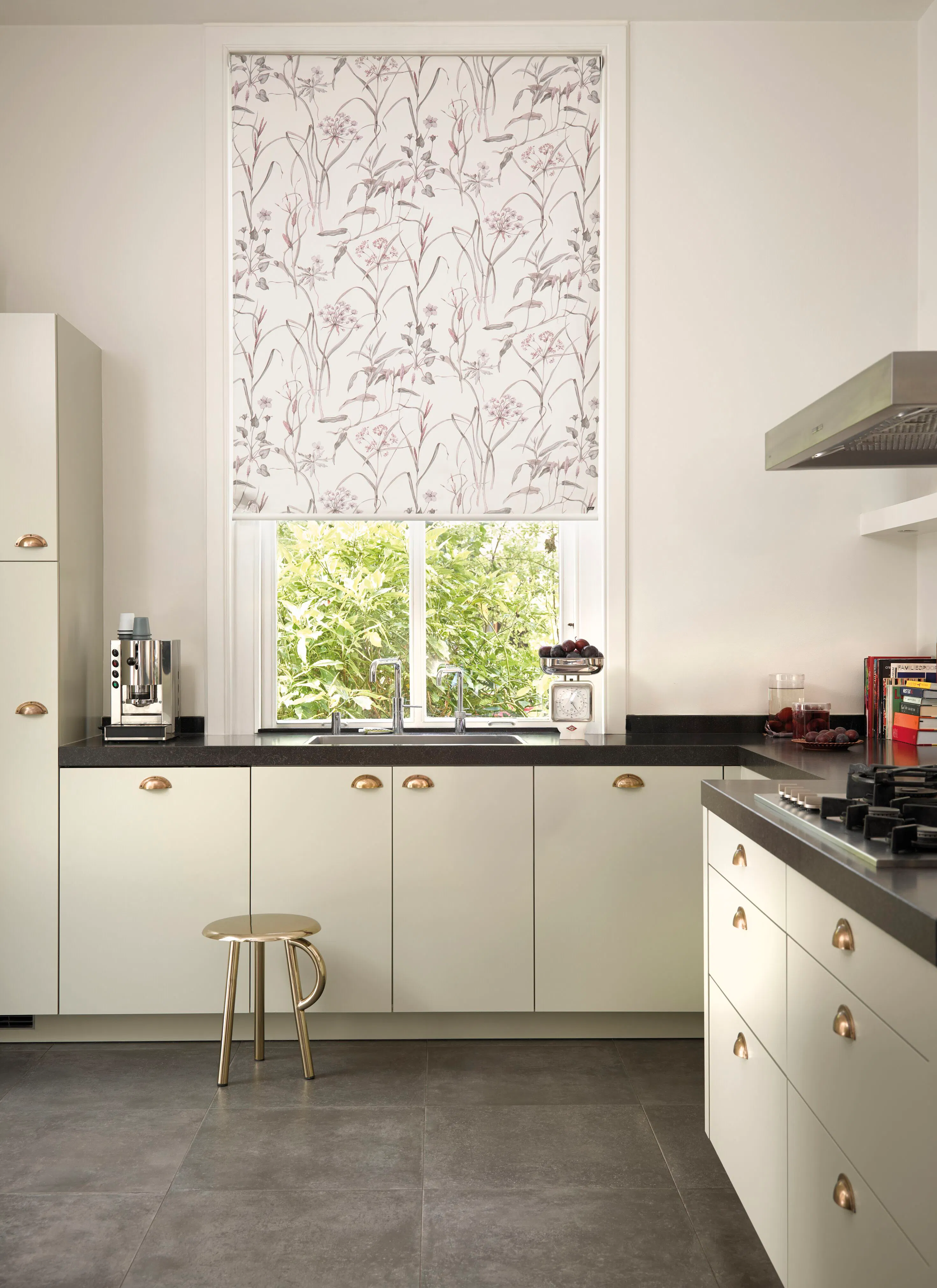 Pink and white floral roller blind in a kitchen window