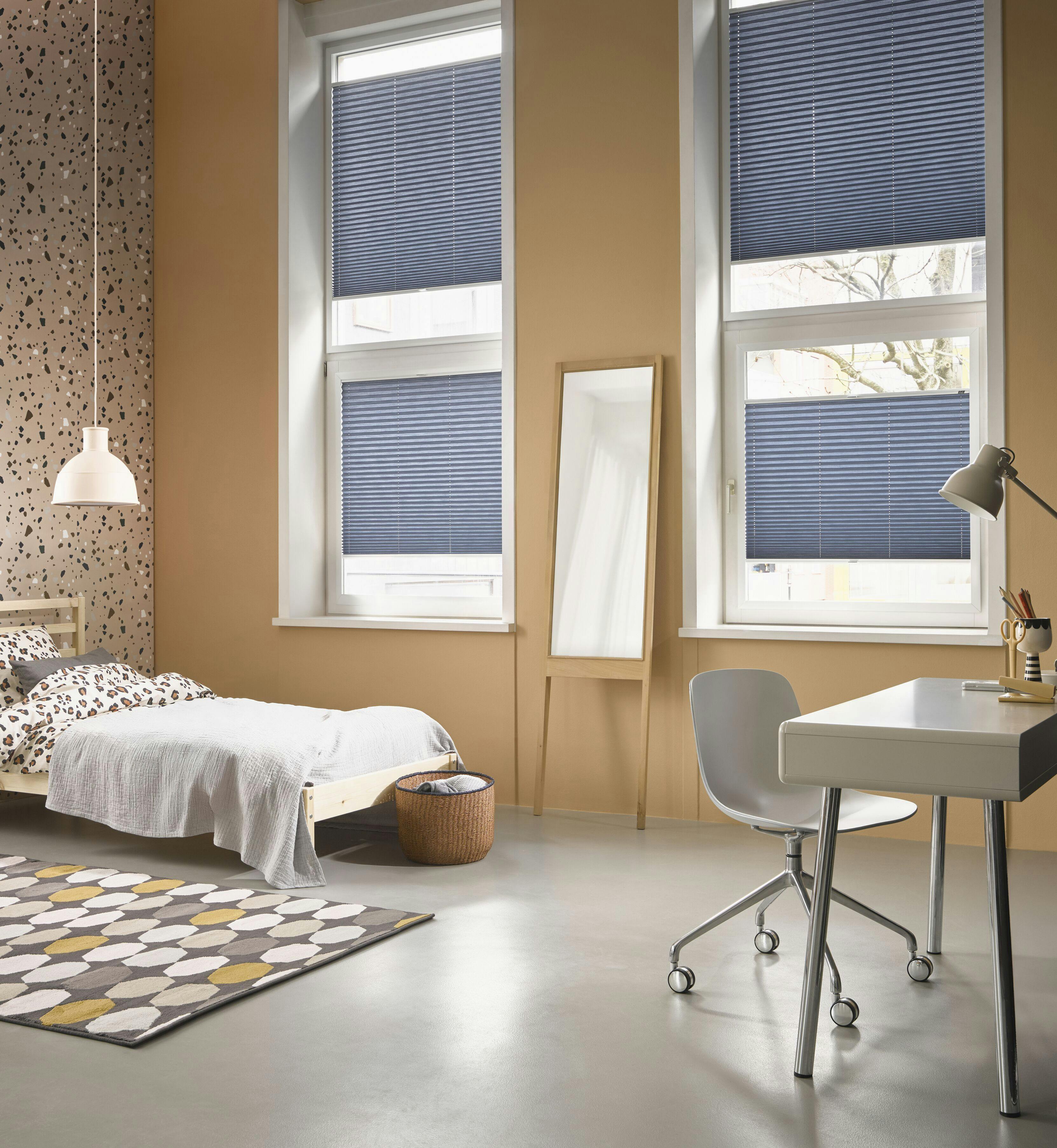 Blue plisse blinds in windows in a children's bedroom