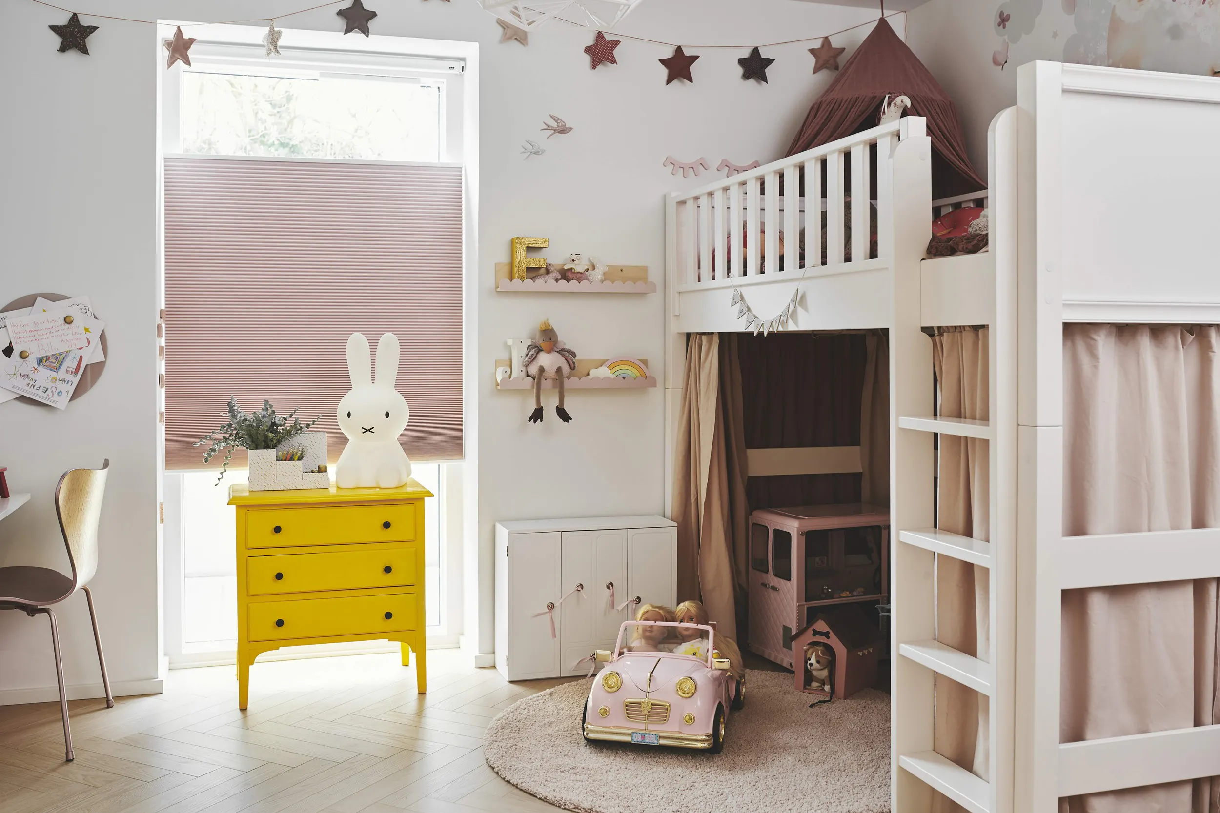 Pink Duette® shades on windows in a kid's room