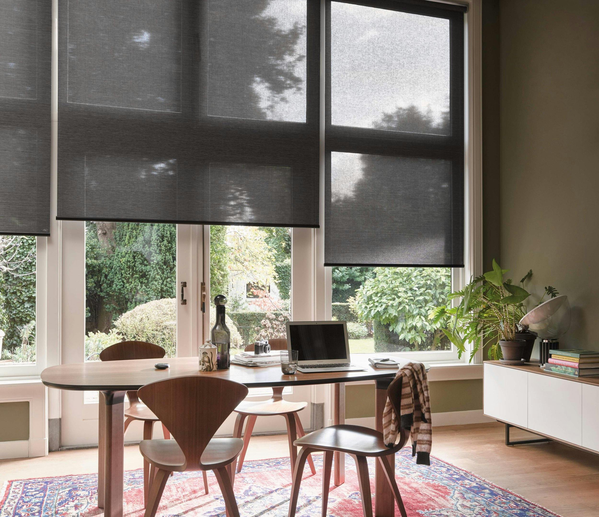 Dining room with black roller blinds 