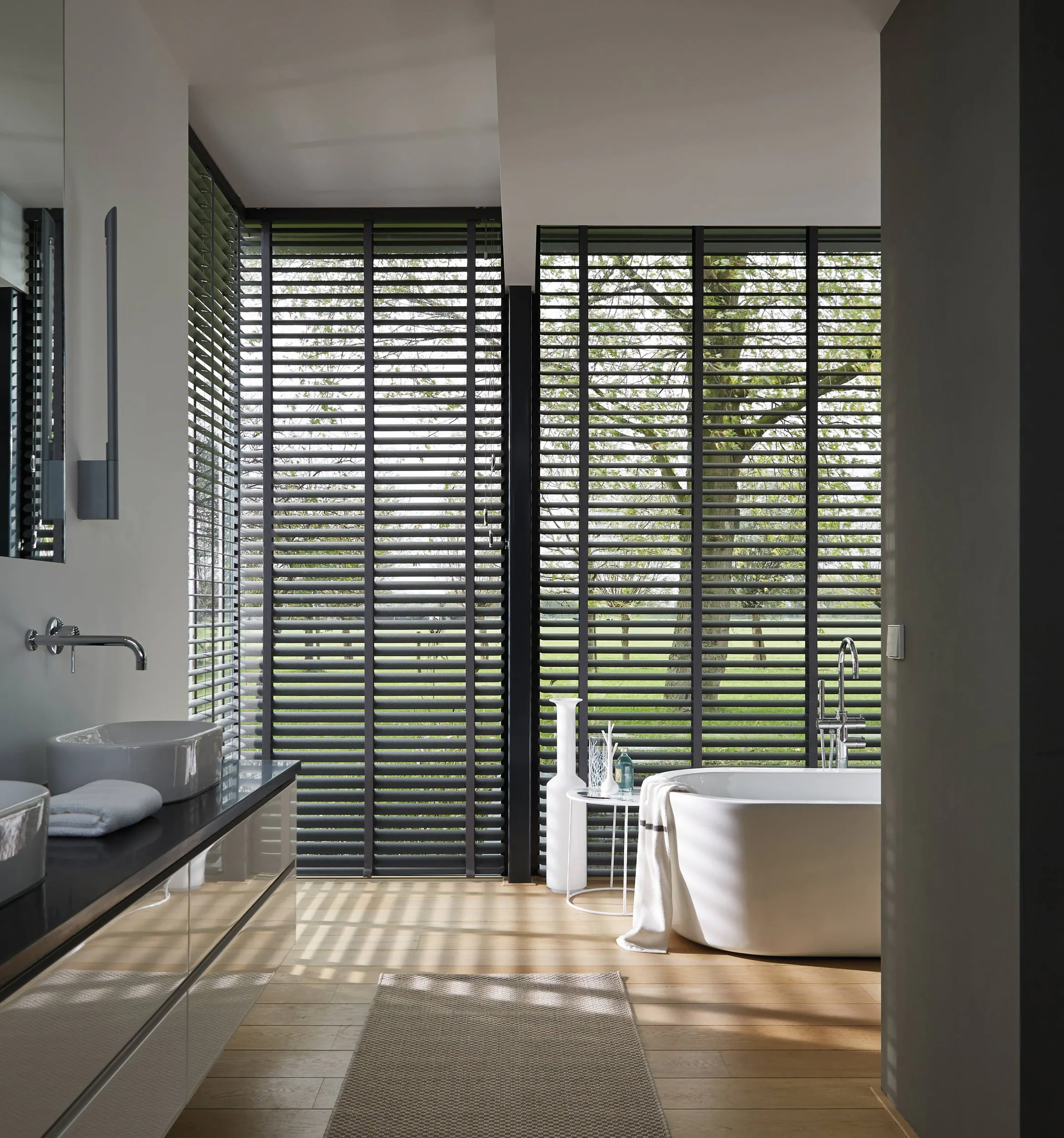 Modern bathroom with brown venetian blinds on large windows
