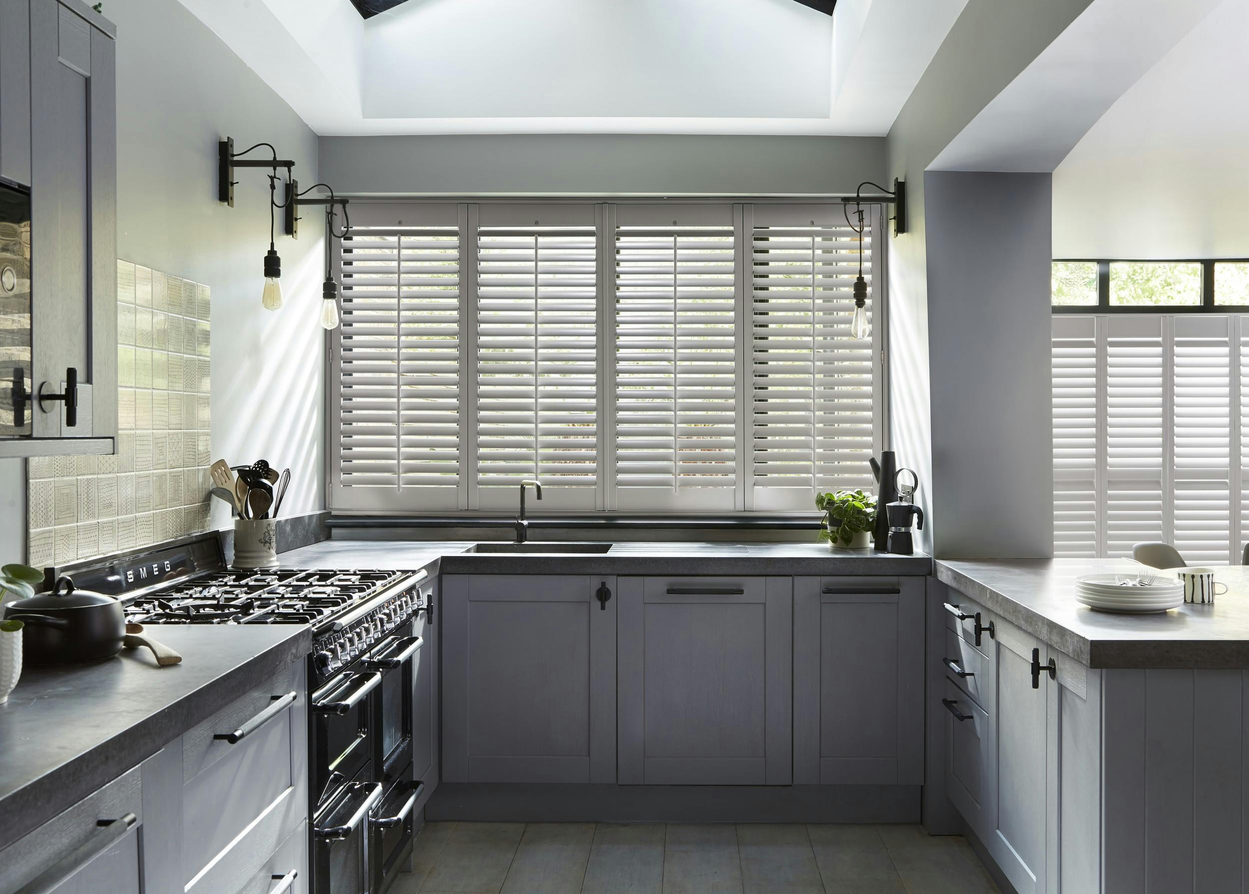 Light grey shutters on windows in a modern kitchen