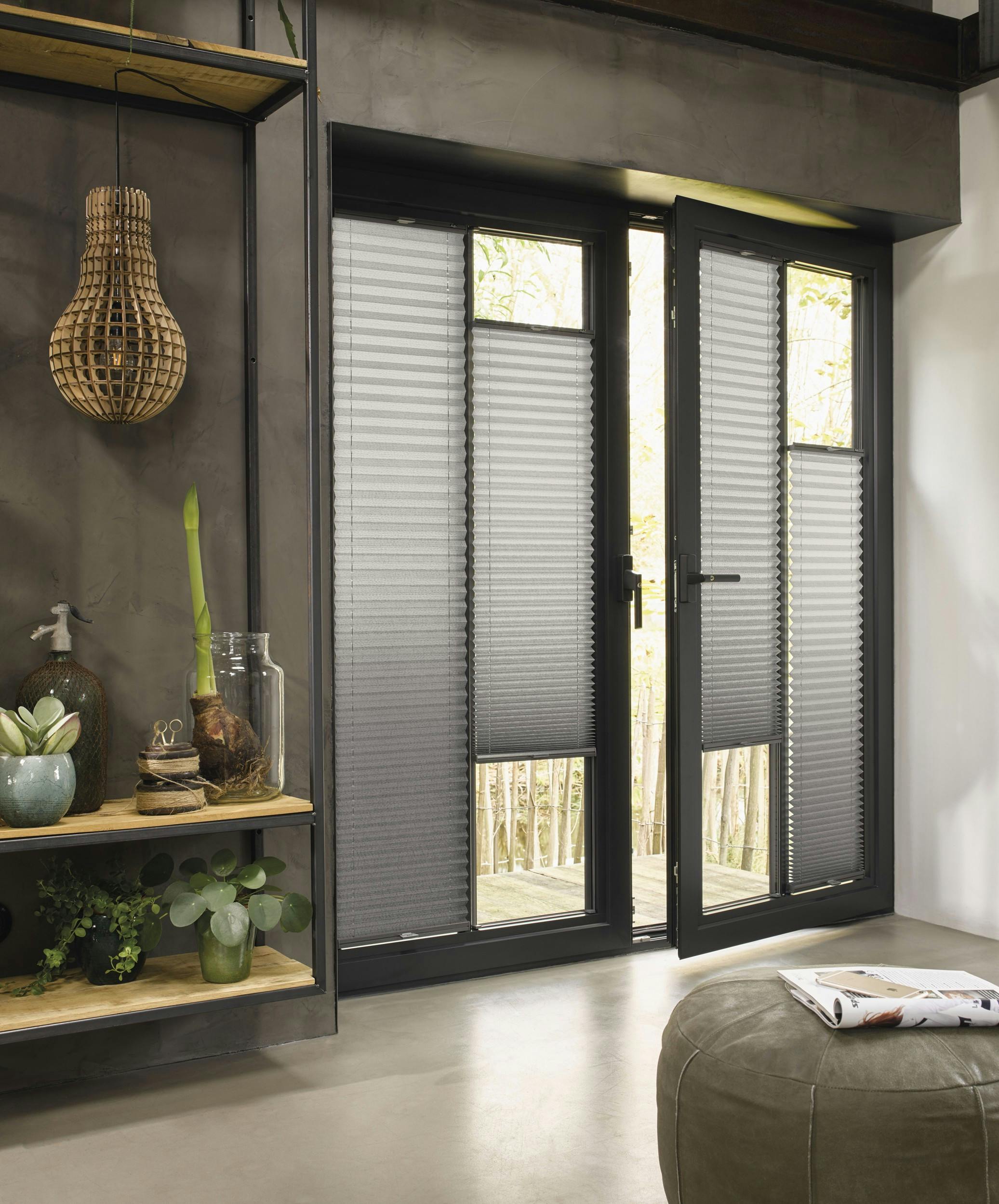 Modern living room with grey plissé shades on screen doors