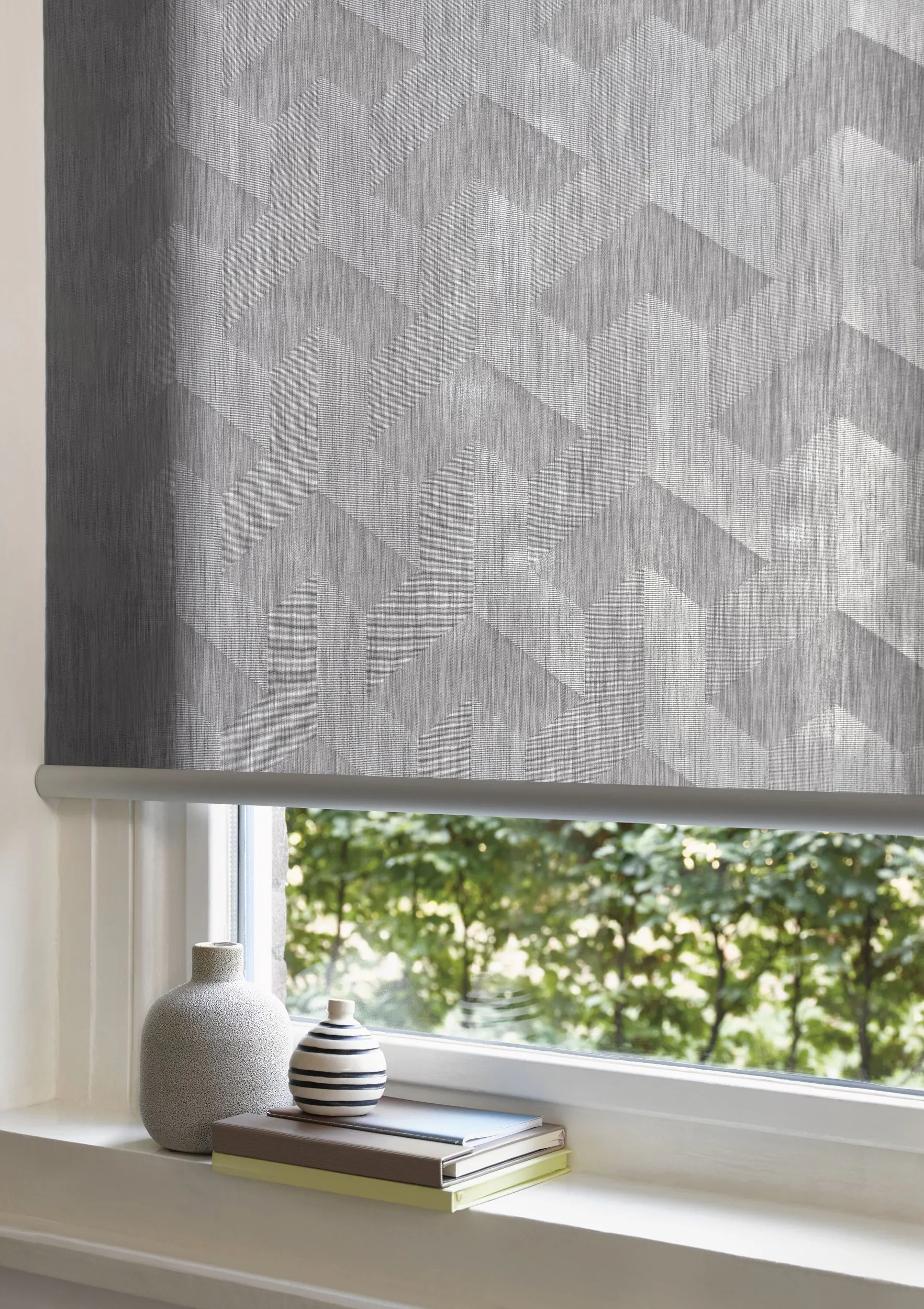 Living room with grey design roller blinds