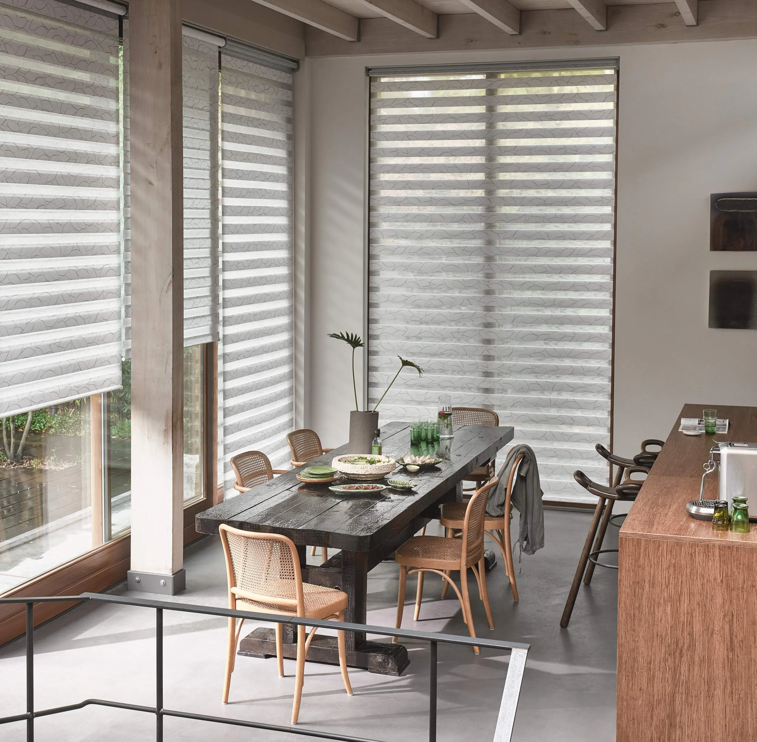 Light dining room with white duo roller blinds on windows