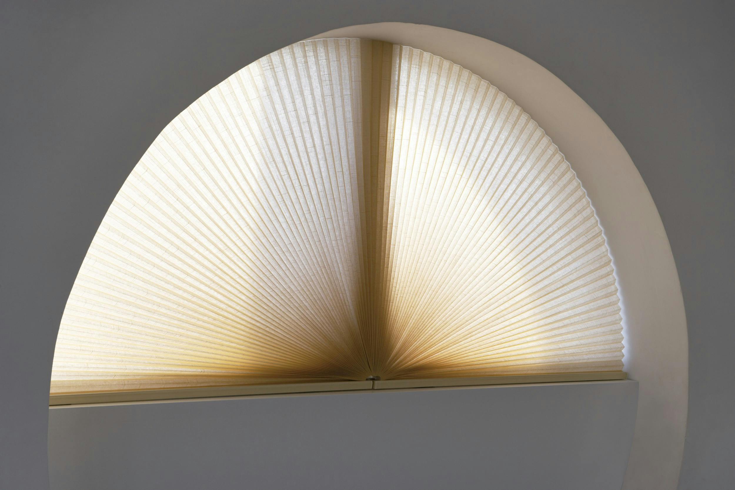 Yellow duette shades on shaped windows