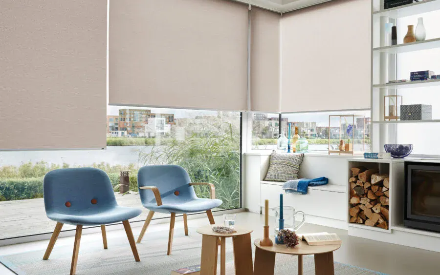Cream roller blinds on large windows in a modern living room