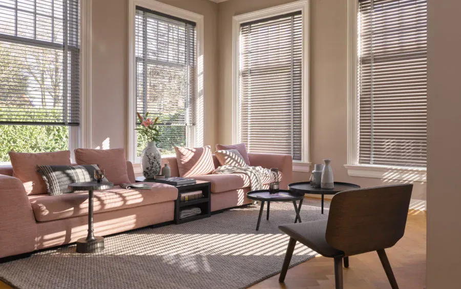Beige venetian blinds on windows in a cosy living room