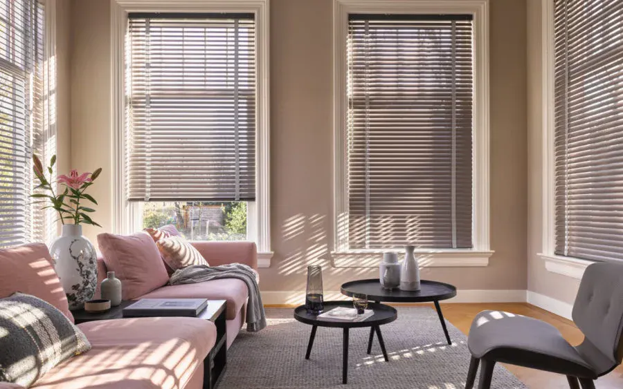 Beige venetian blinds on windows in a cosy living room