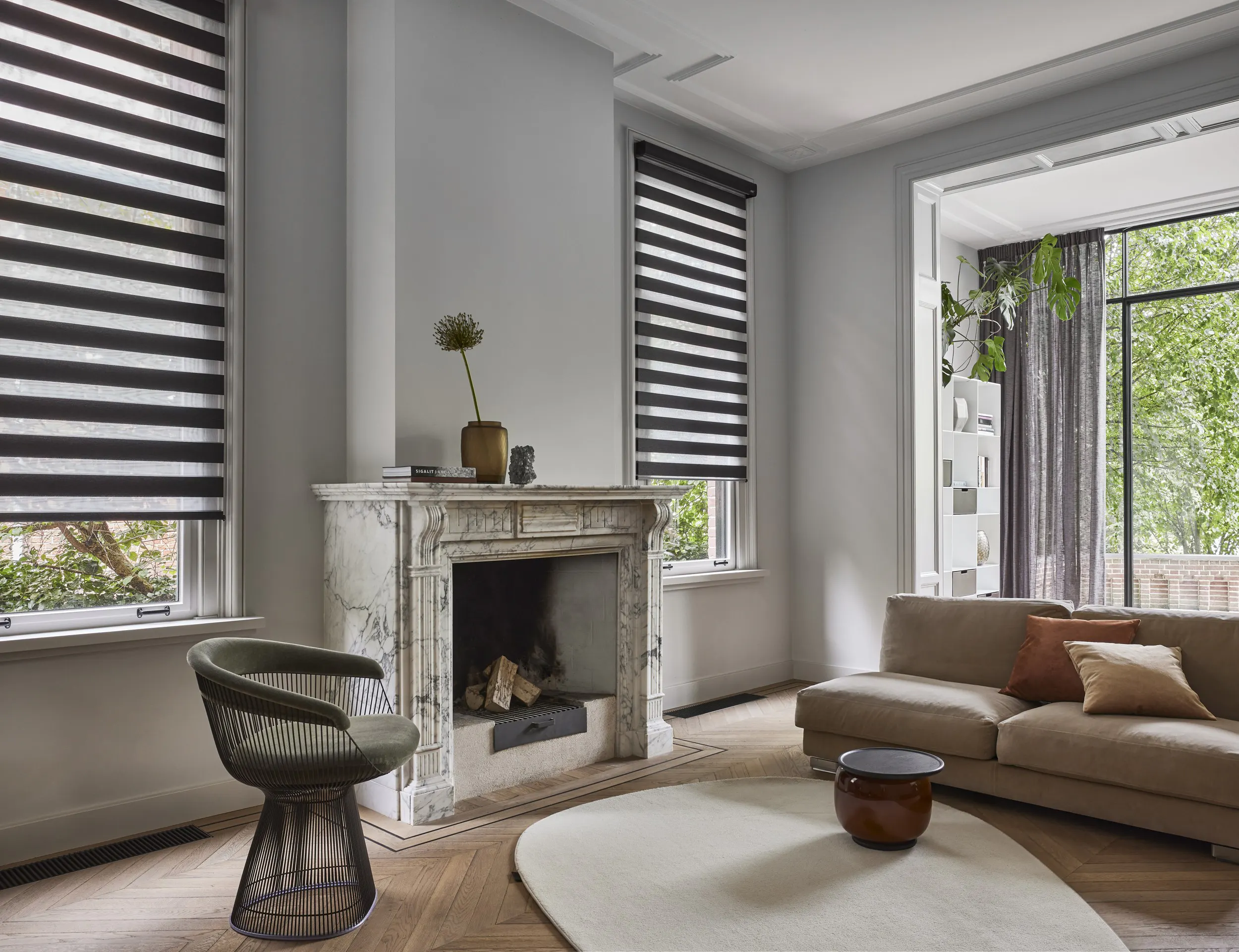 A spacious living room with brown duo roller blinds on windows