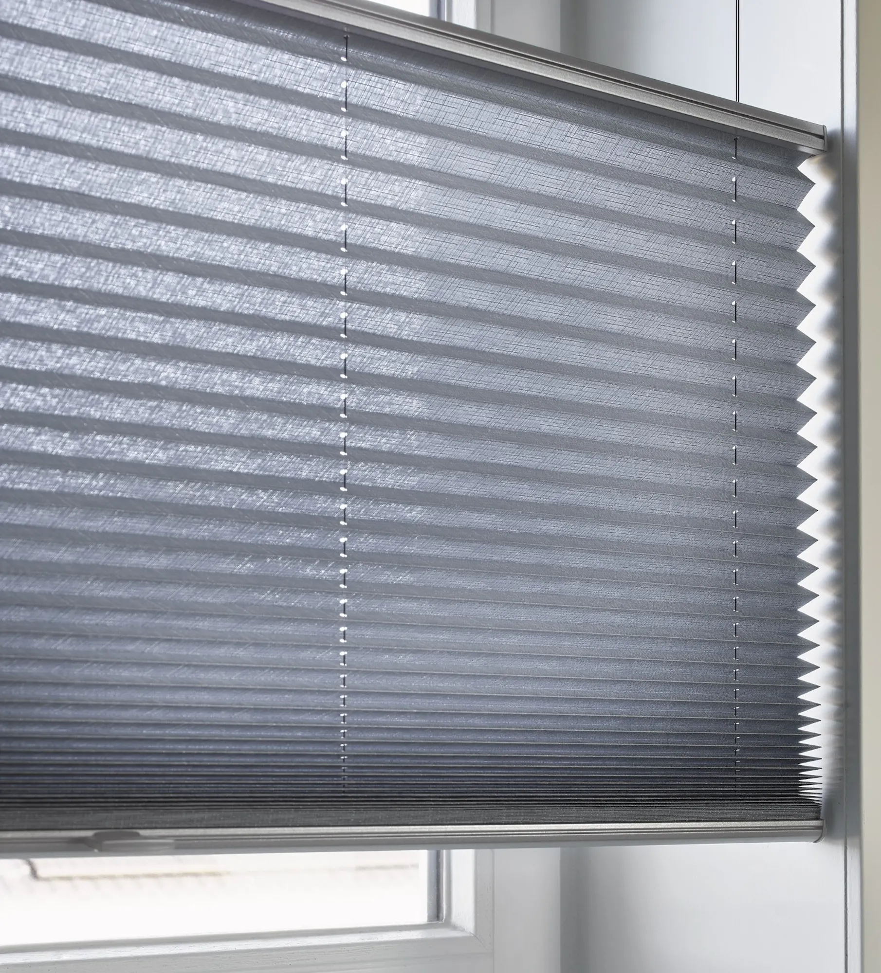 Closeup of blue plisse shades with top down/bottom up feature