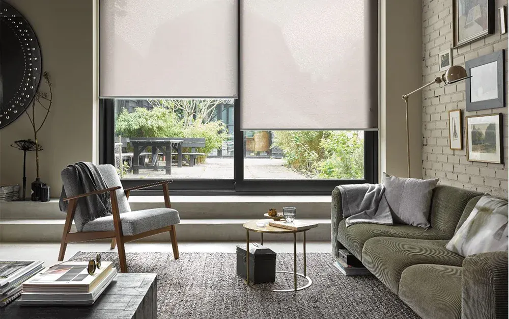 White roller blinds on large window in a living room
