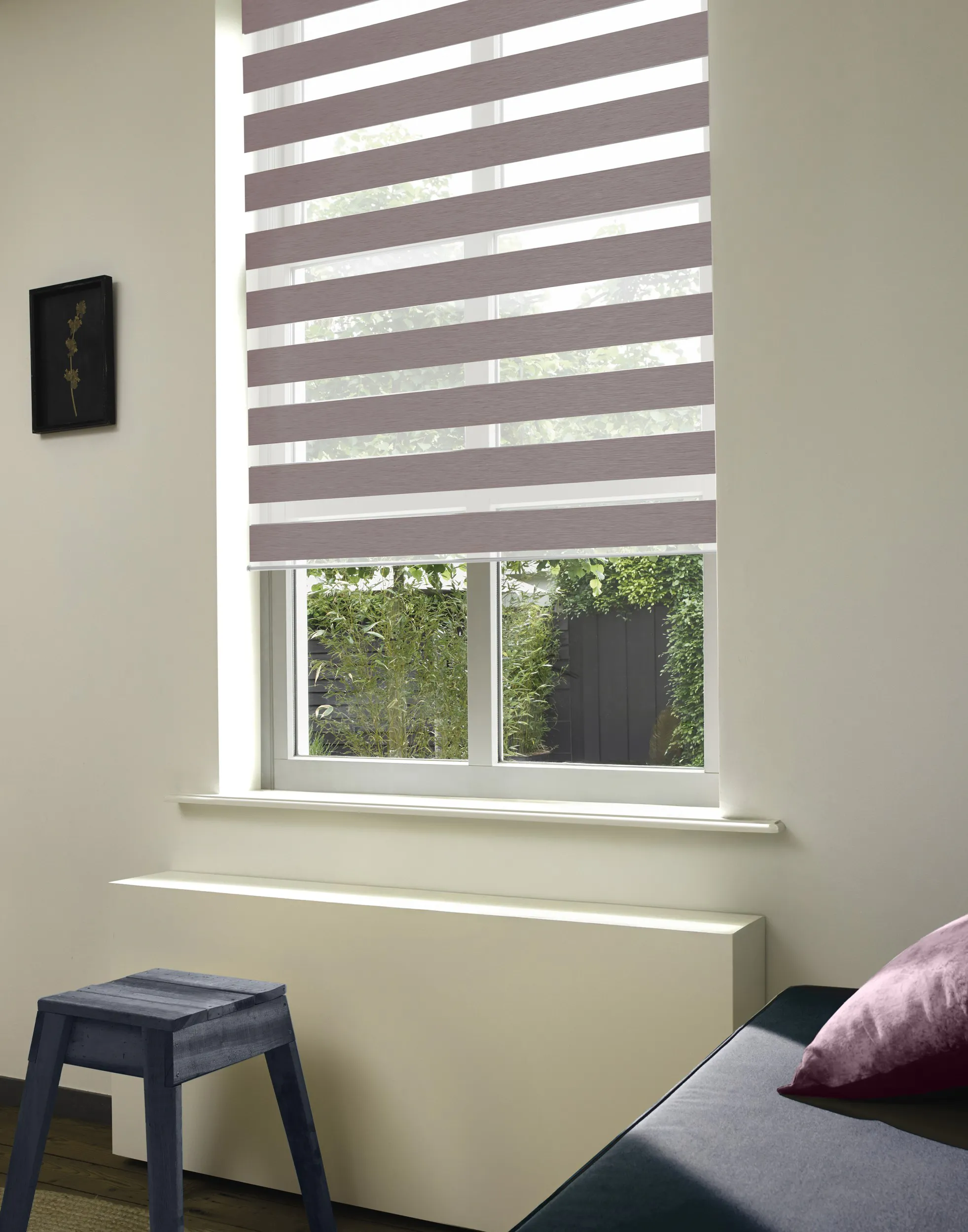 Brown duo roller blinds on a window in bedroom 