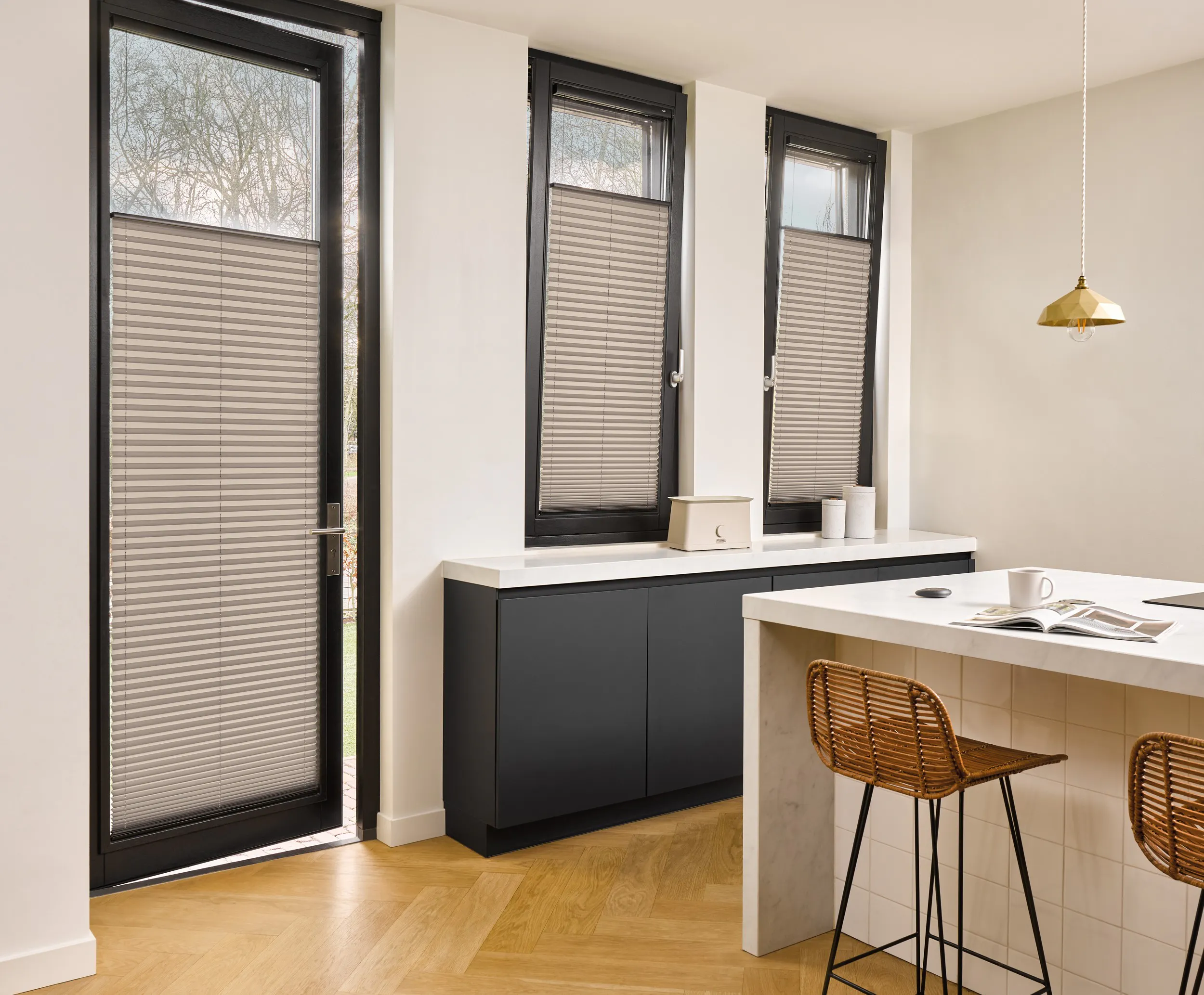 Grey plisse shades on door and windows in a kitchen 