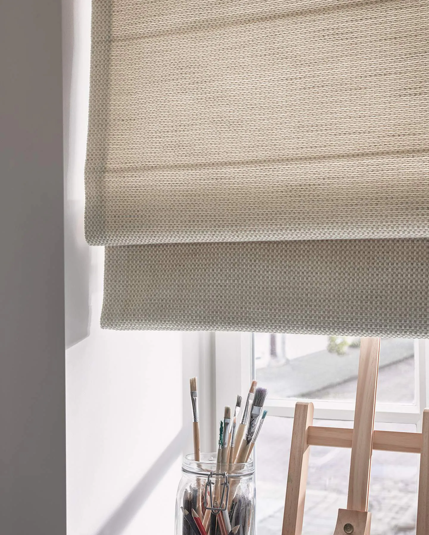 Cream roman blinds in a painting room