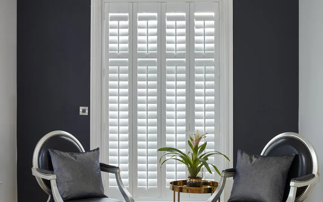 White shutters in a closed position in a living room