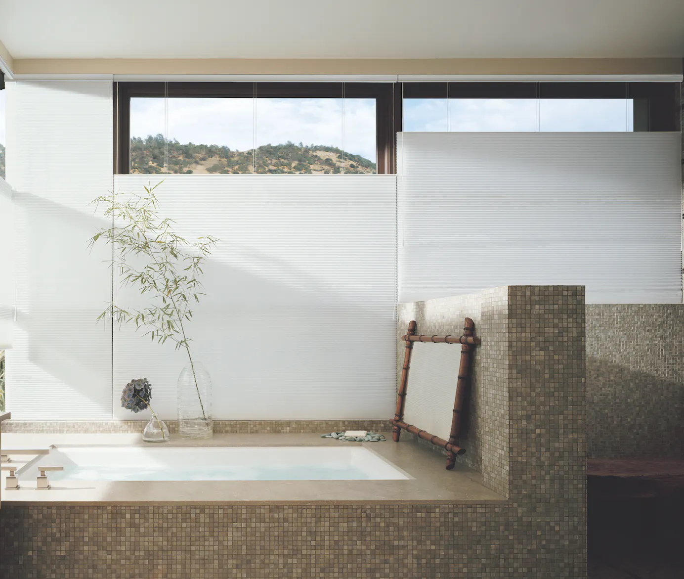 White duette shades in a bathroom with a bathtub