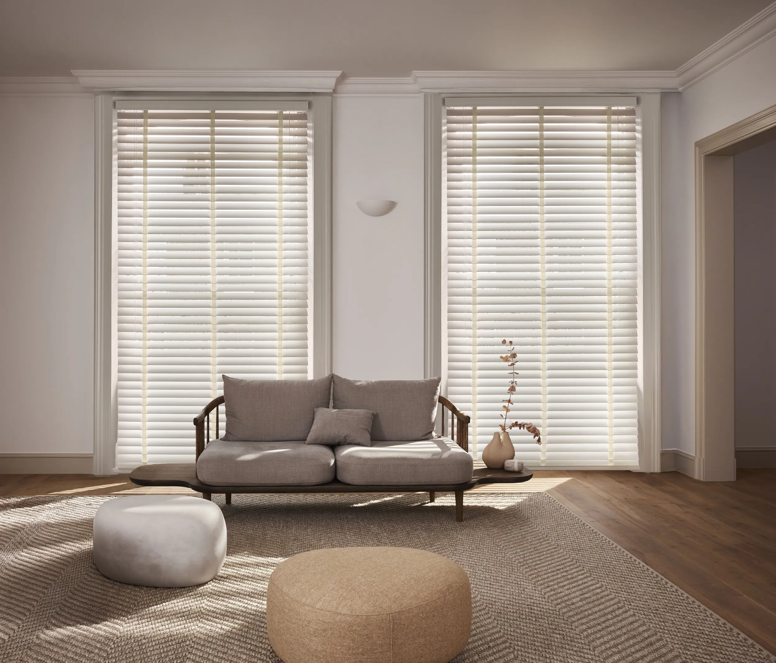Spacious living room with cream venetian blinds on large windows 