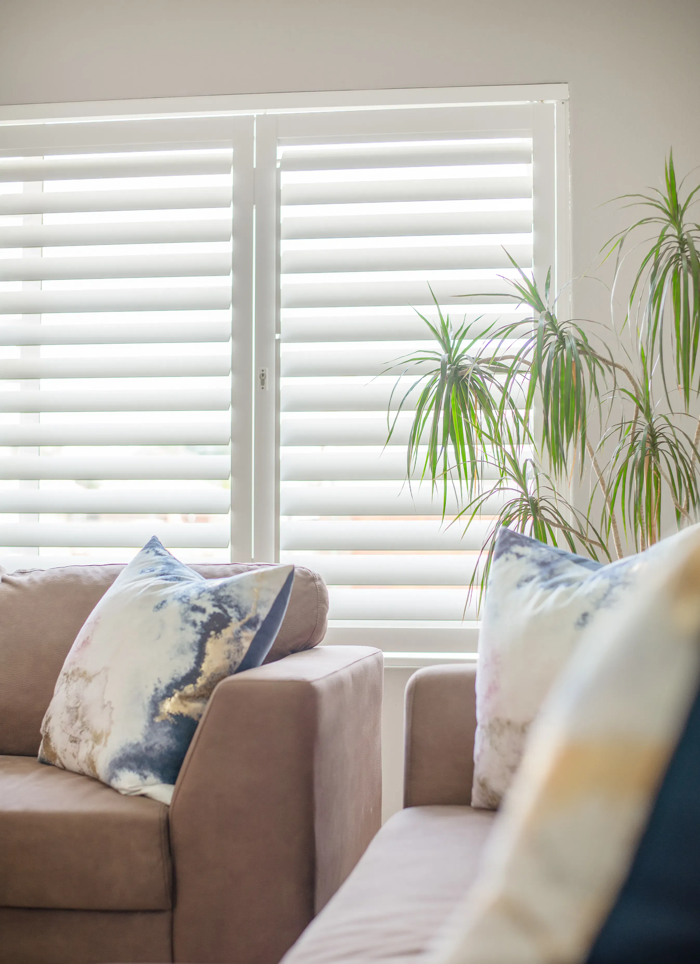 ShutterX white bifold shutter in a living room