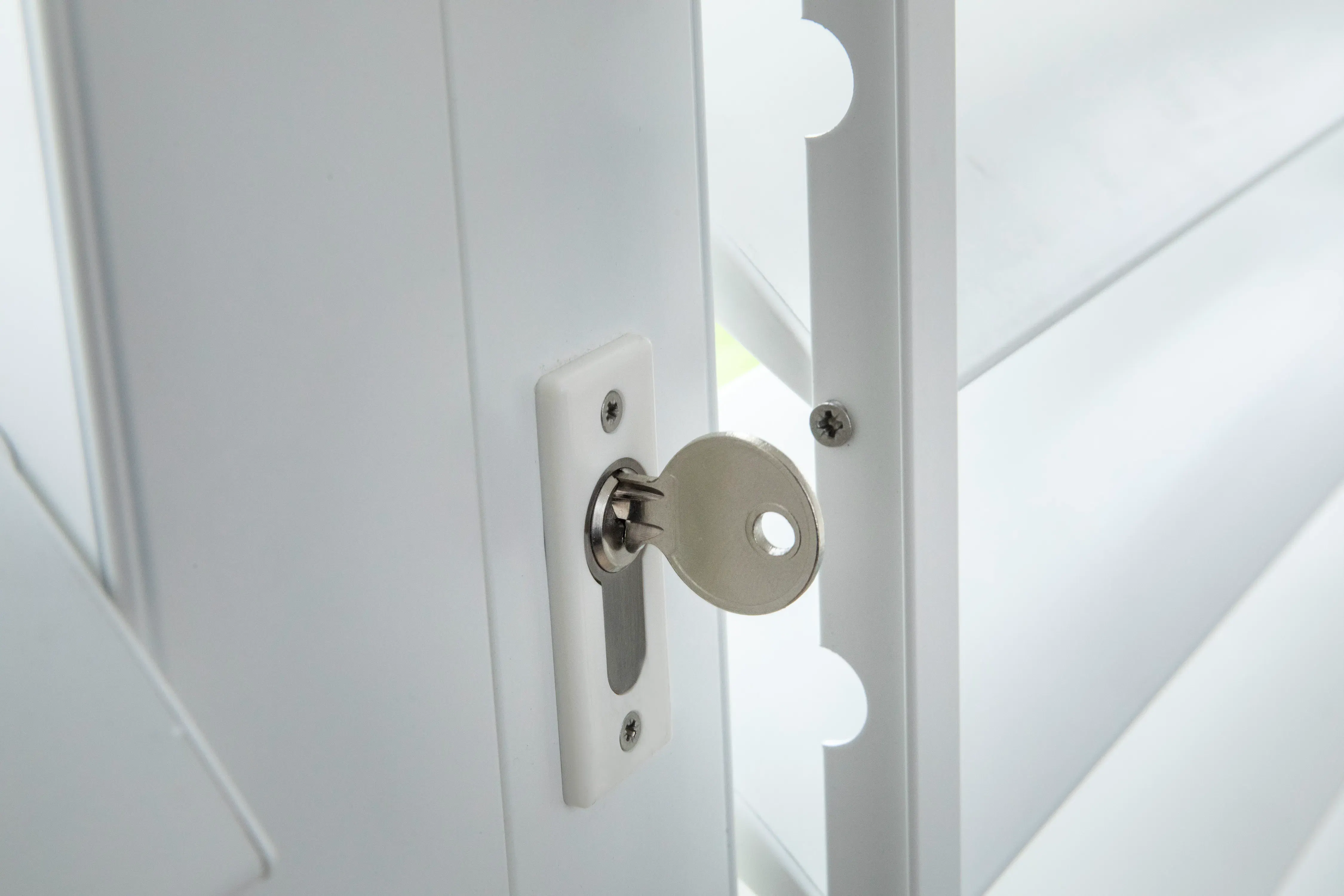 Closeup of a ShutterX white shutter with a security lock