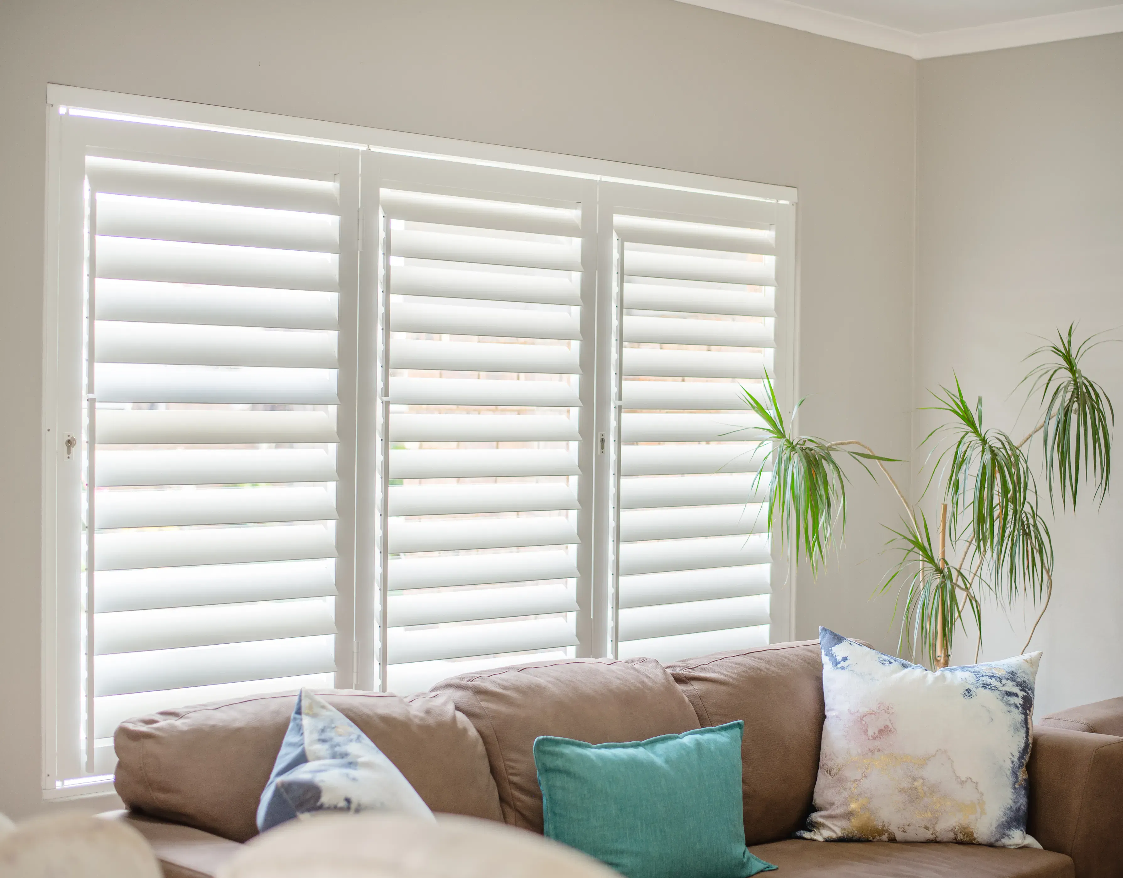 ShutterX white bifold shutter in a living room