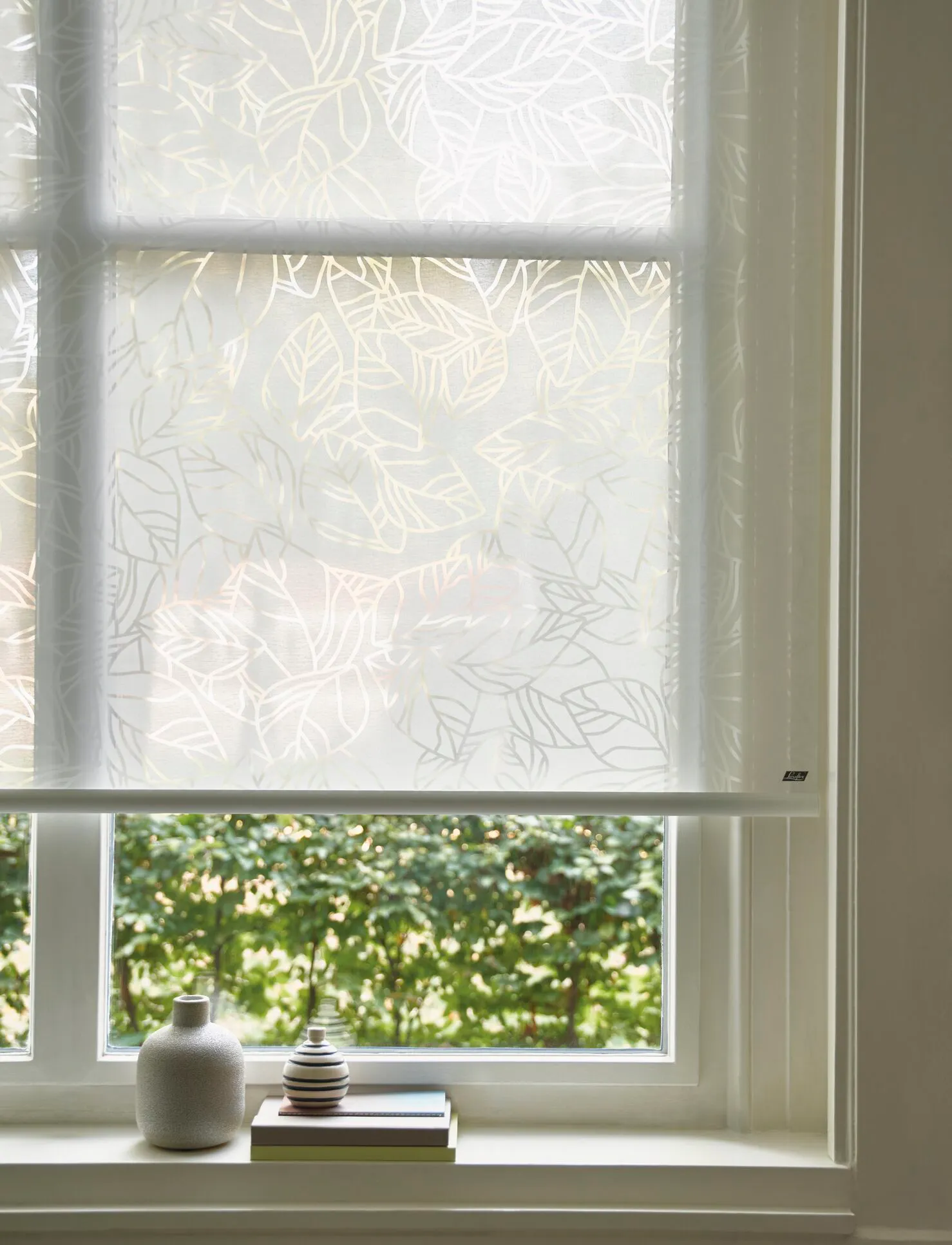 White translucent roller blinds with floral designs