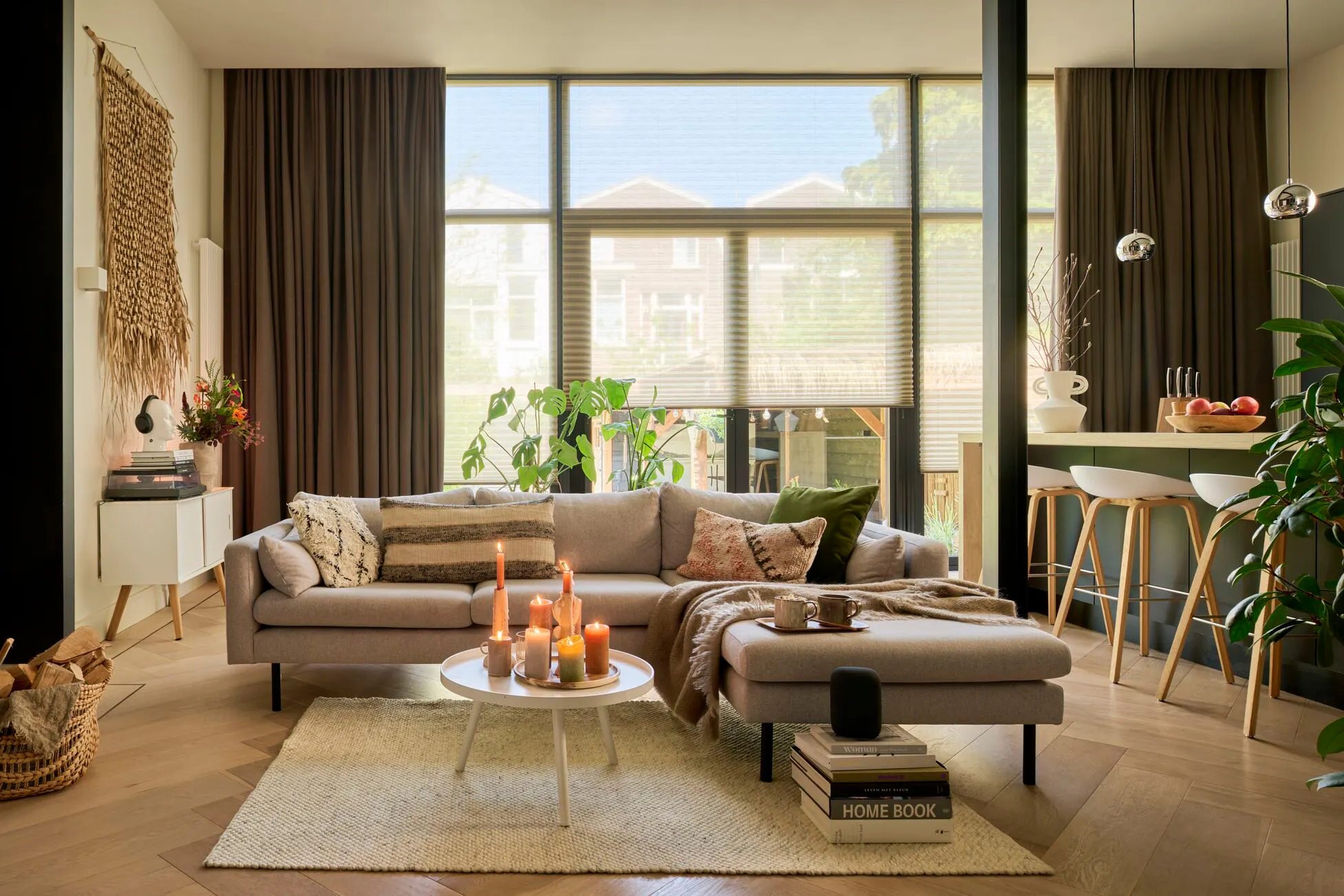 White transparent plisse shades layered with brown curtains in a living room
