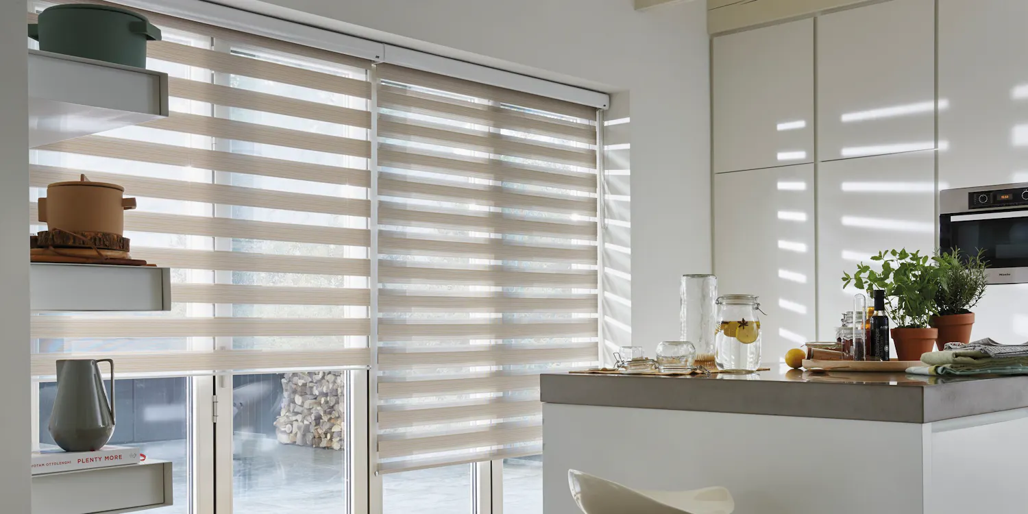 Cream duo roller blinds in a kitchen