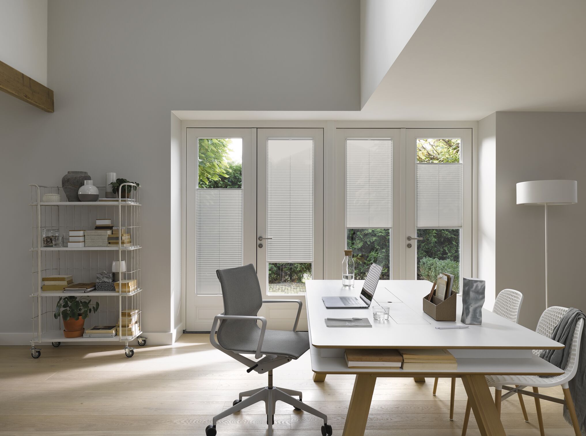 Grey plisse blinds in a home office