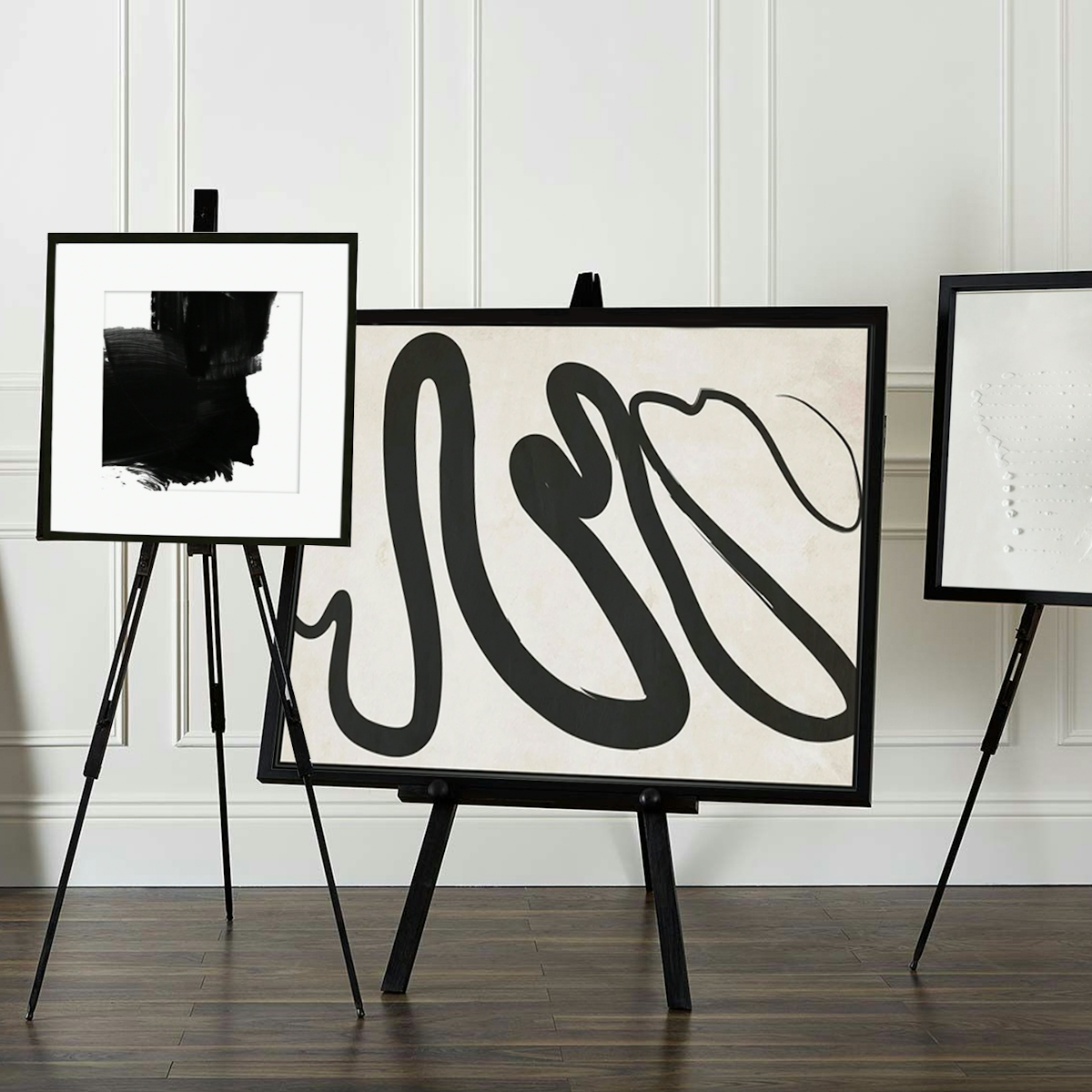 Abstract canvases on easels in monochrome colours