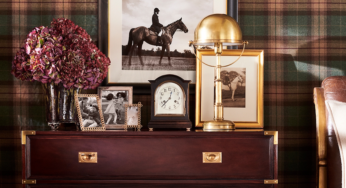 Ralph Lauren brass table lamp on chest of drawers with photo frames and equestrian photo