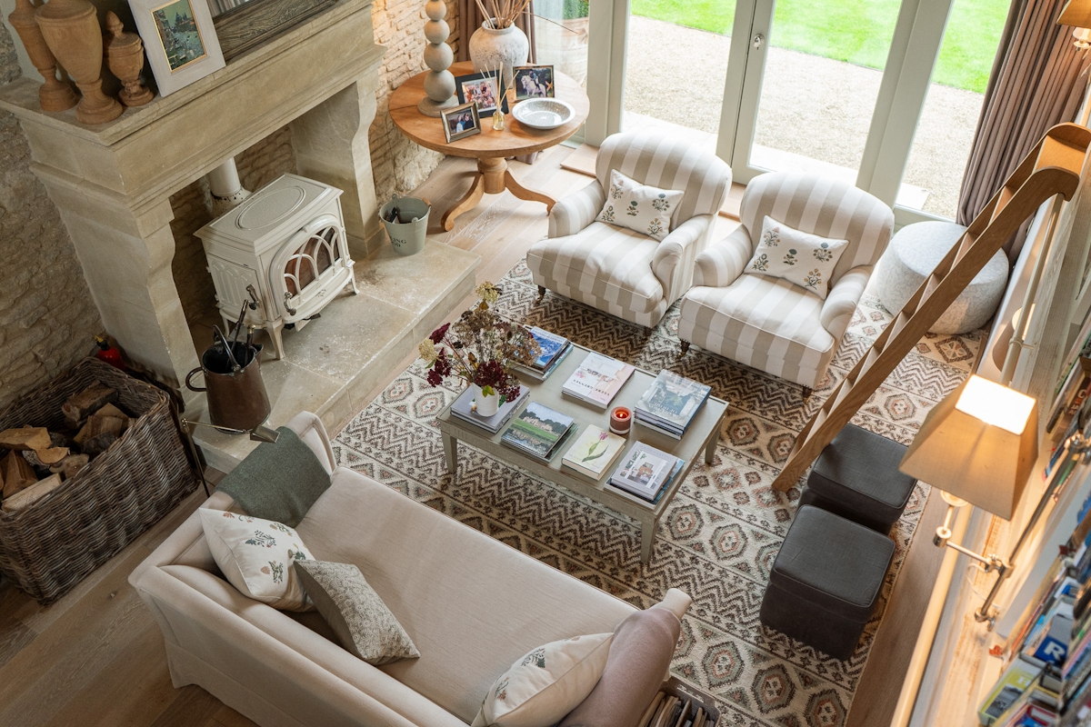 Emma Sims-Hilditch designed living room with log burner, coffee table and linen upholstered sofas and armchairs.