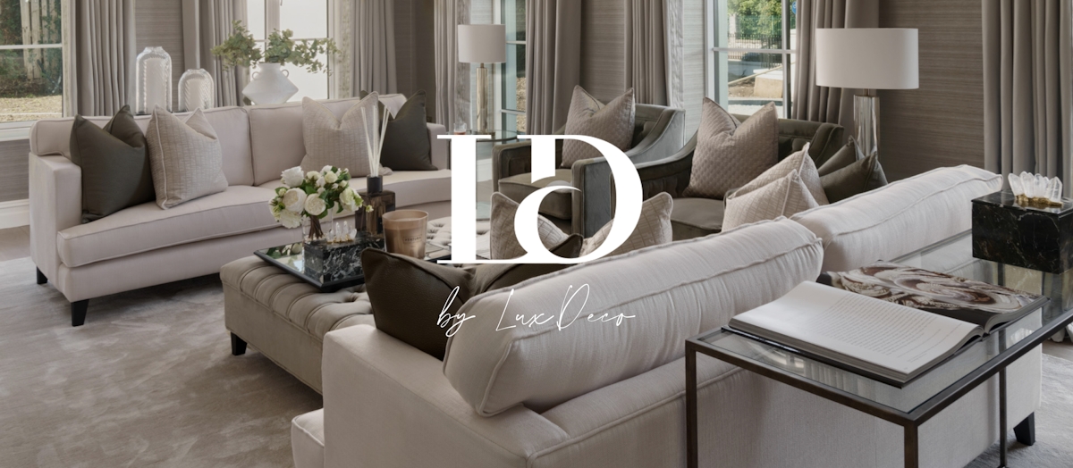LD by LuxDeco living room with two sofas, ottoman and console table with white logo