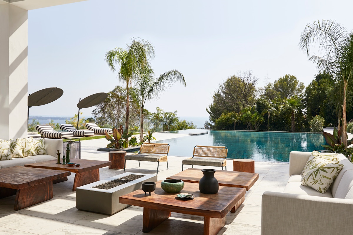 Mid-century modern villa with teak outdoor furniture and large swimming pool
