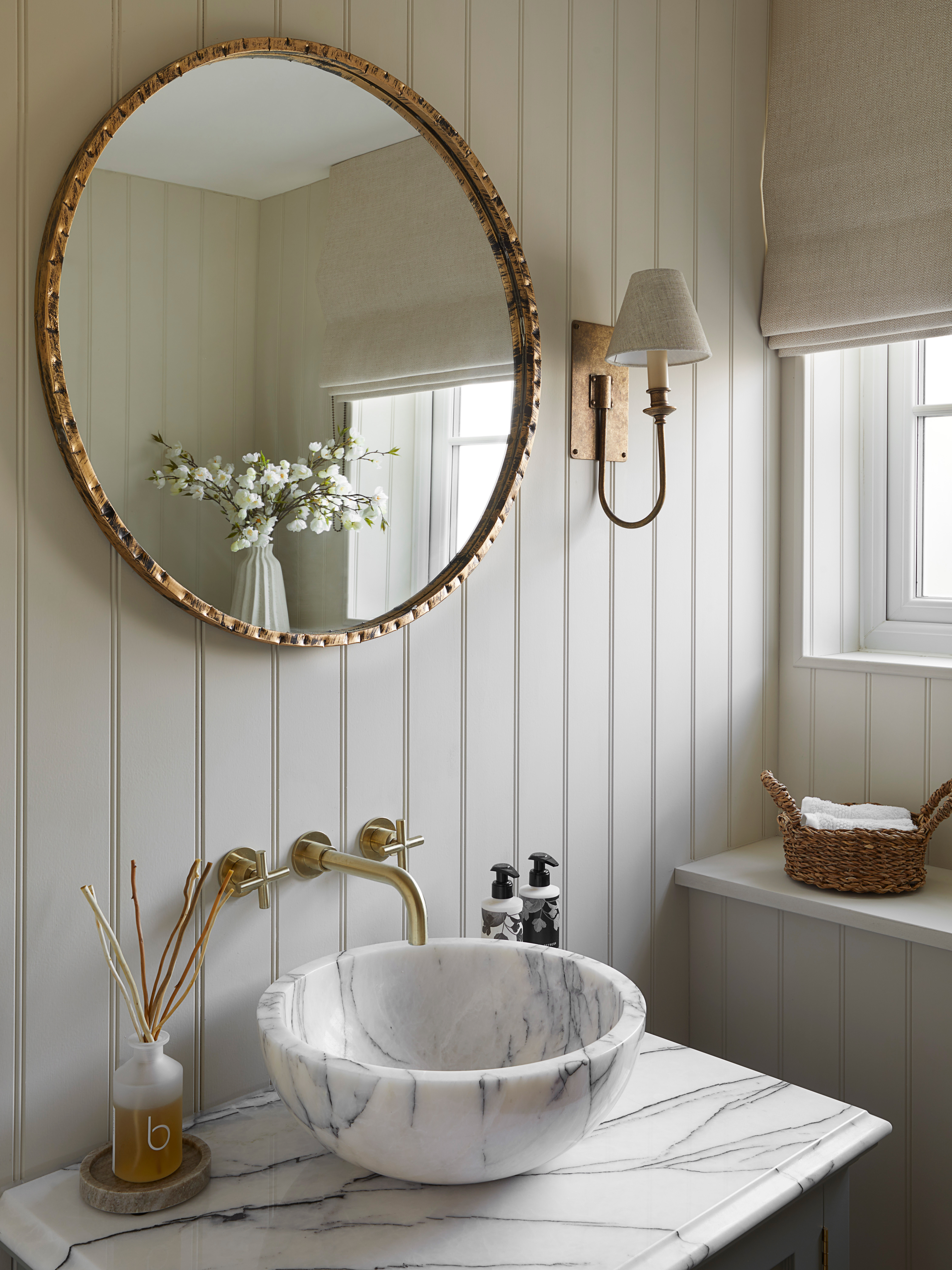 Attractive marble basin sink on marble countertop with brass hardware details