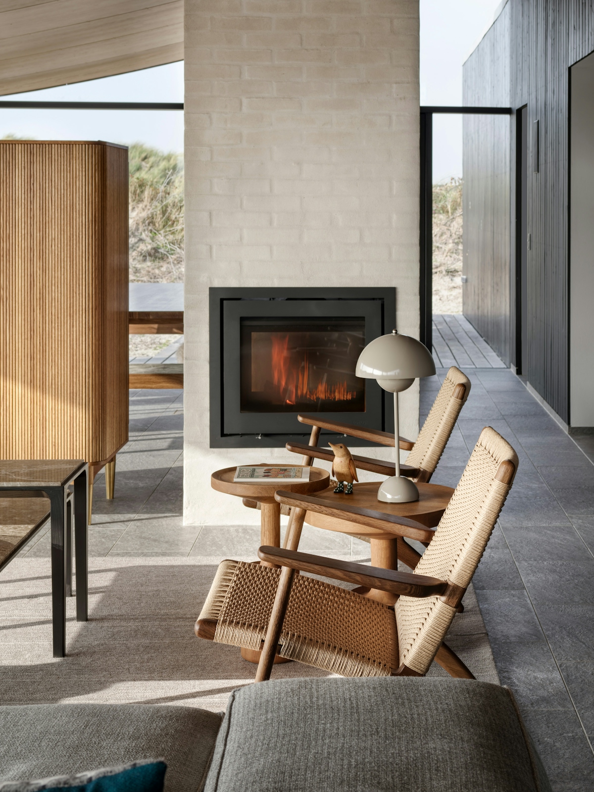 Tollgard studio Danish summer house with fireplace and wooden armchairs