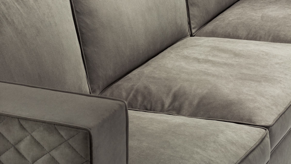 Close up of a grey velvet luxury sofa