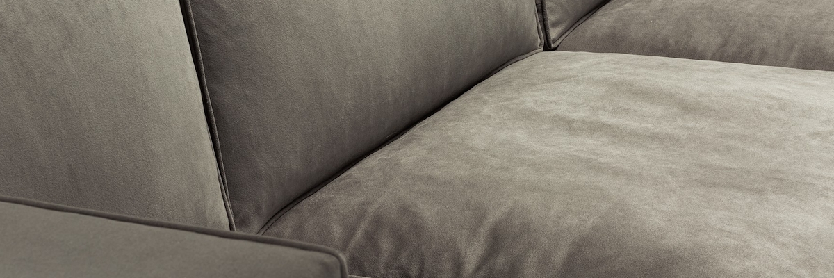 Close up of a grey velvet luxury sofa