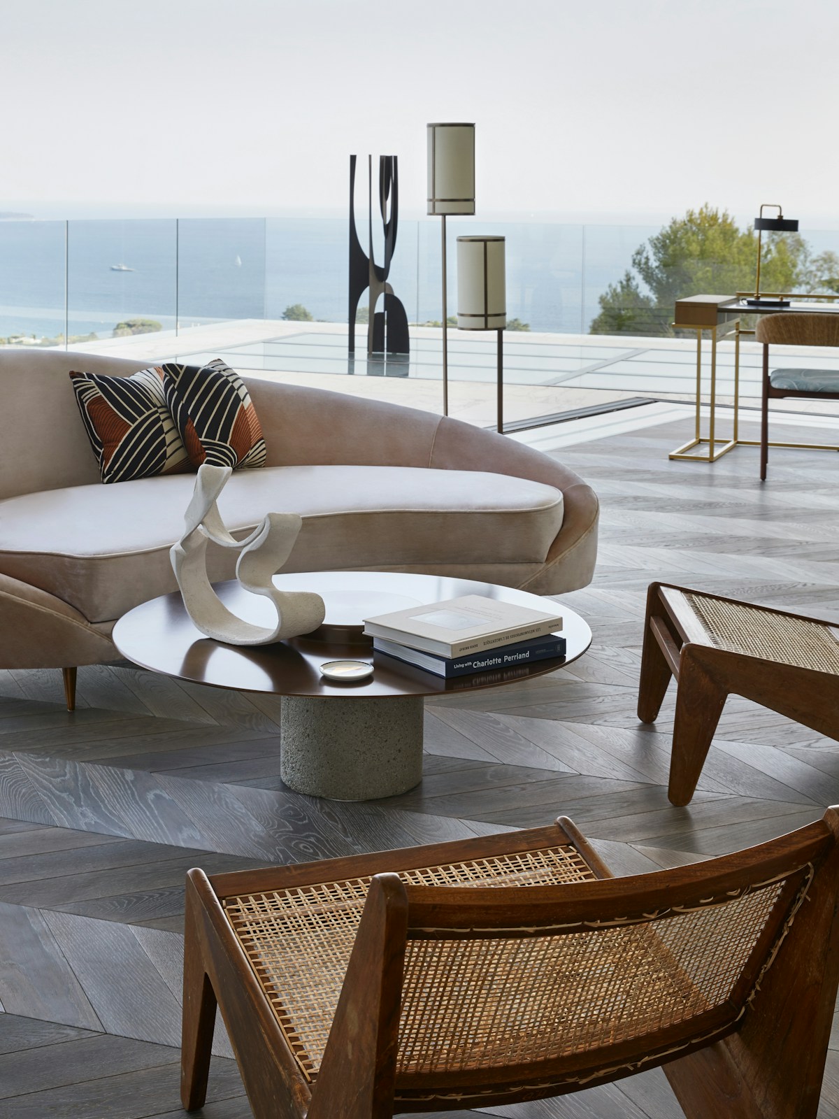 Humbert & Poyet Villa Odaya Mid-century Modern style curved cream sofa and rattanlounge chair