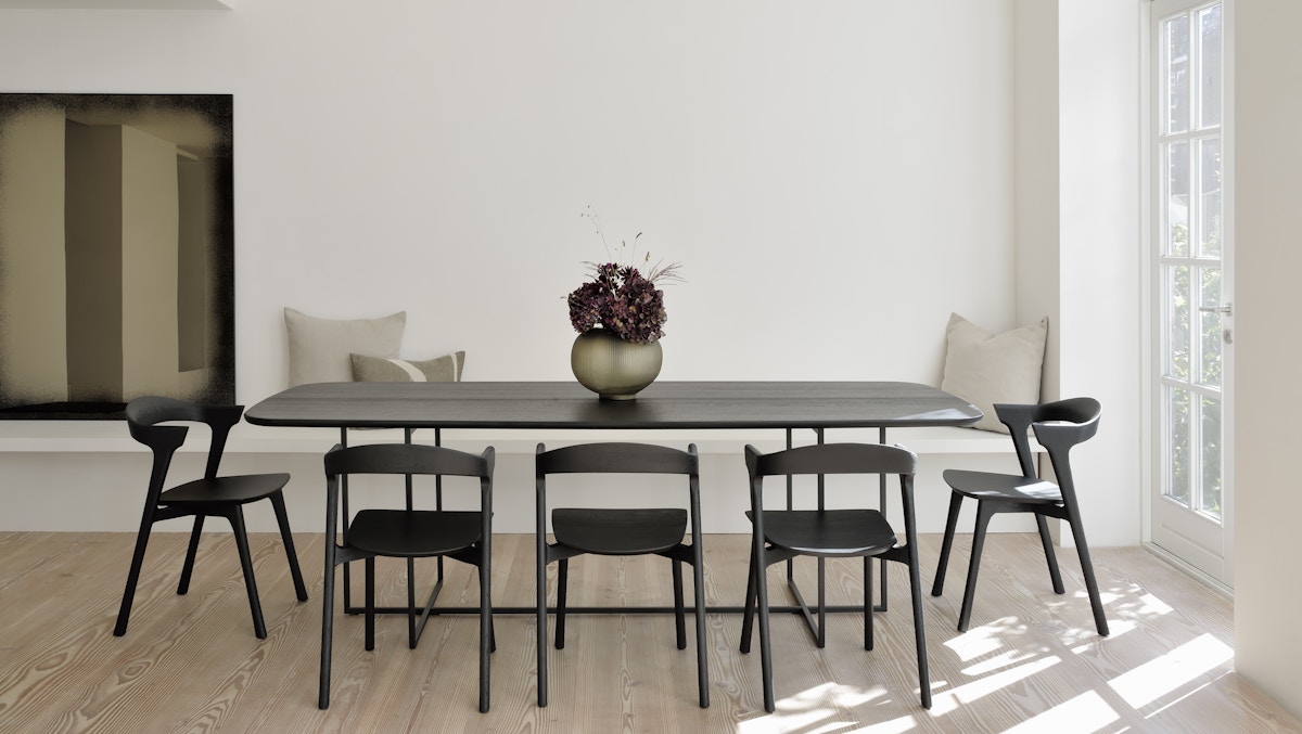 Ethnicraft black Bok oak dining chairs and dining table in minimalist white interior