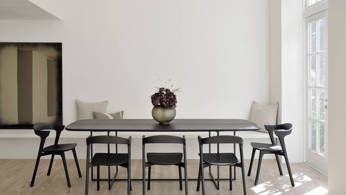Ethnicraft black Bok oak dining chairs and dining table in minimalist white interior
