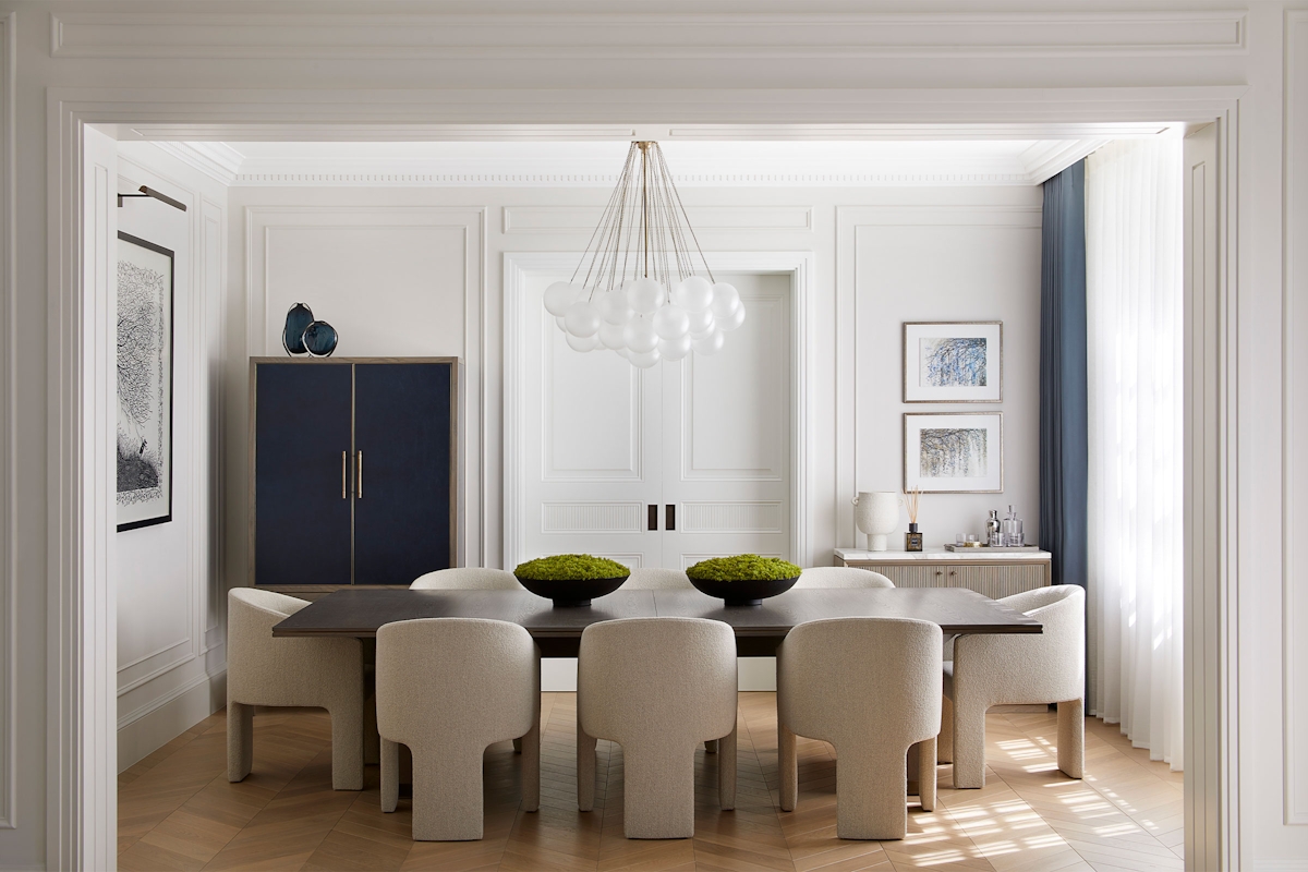 Bright dining room by Andrea Benedettini, with Liang & Eimil Cloud pendant, dark wood table 