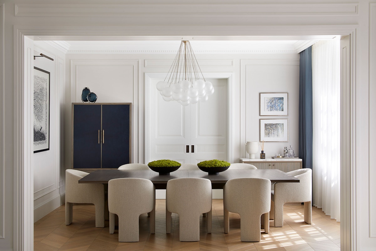 Bright dining room by Andrea Benedettini, with Liang & Eimil Cloud pendant, dark wood table