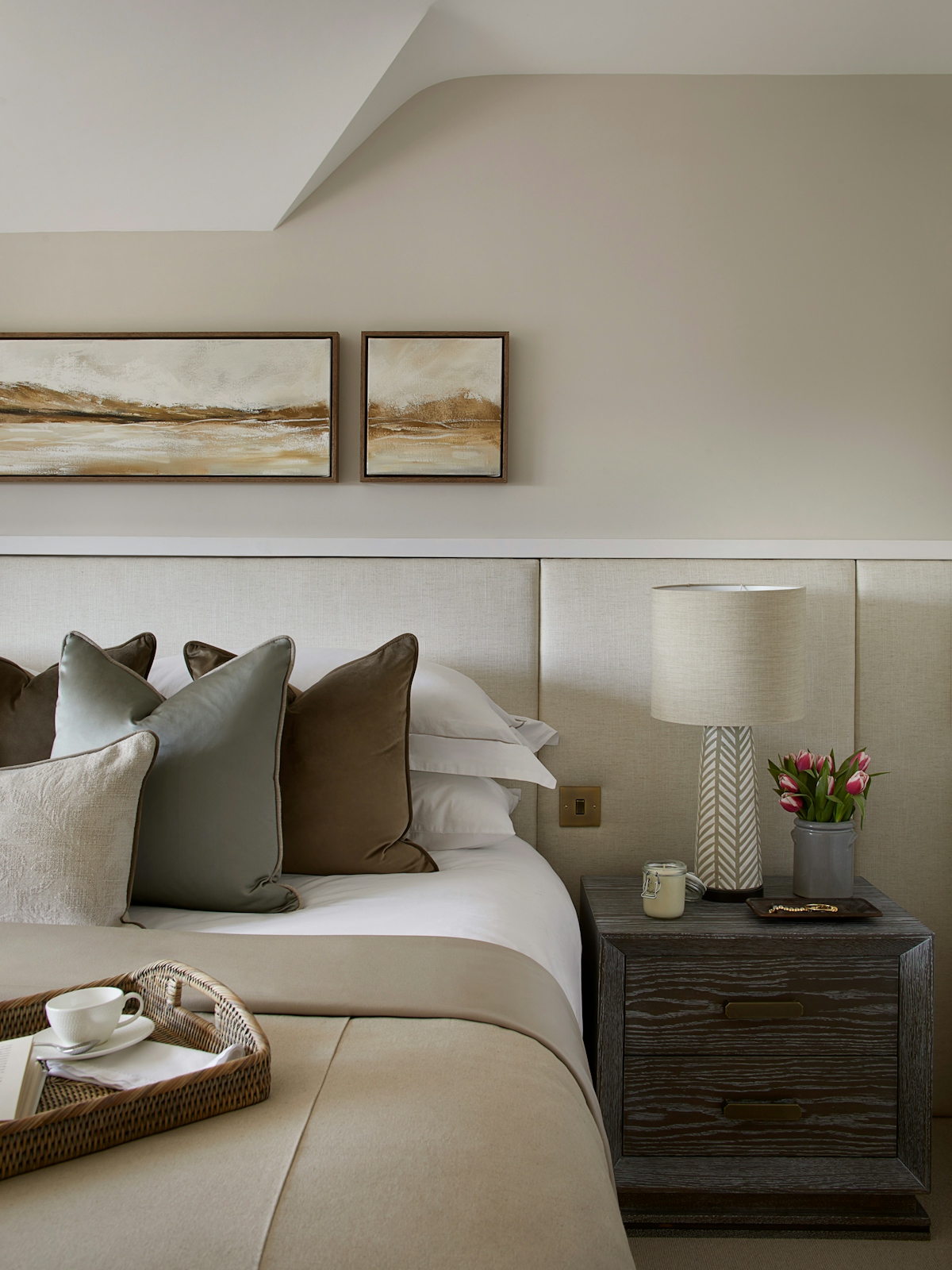 Neutral and inviting bedroom interior with Casper cushion and Headland Triptych by LuxDeco