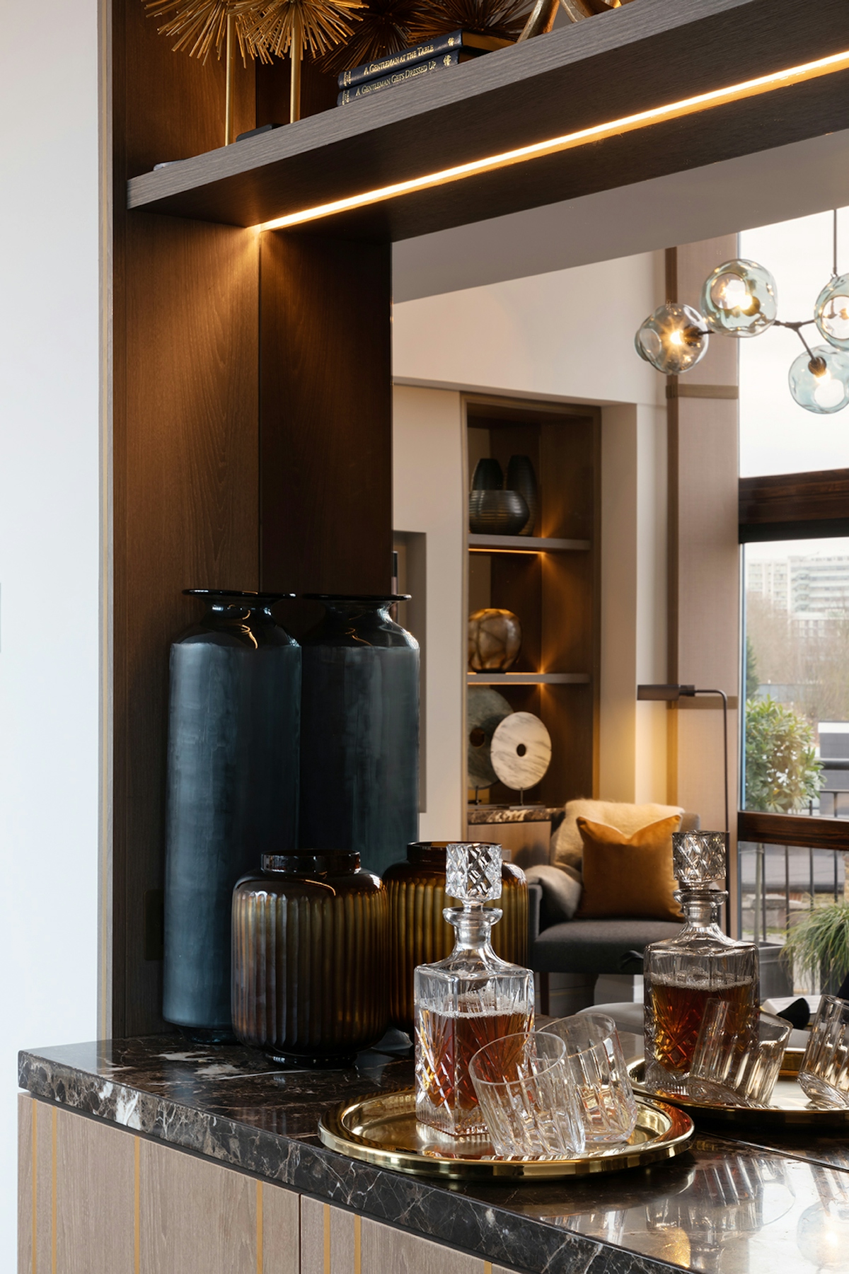 Luxury home bar featuring crystal decanter and elegant vases | LuxDeco.com