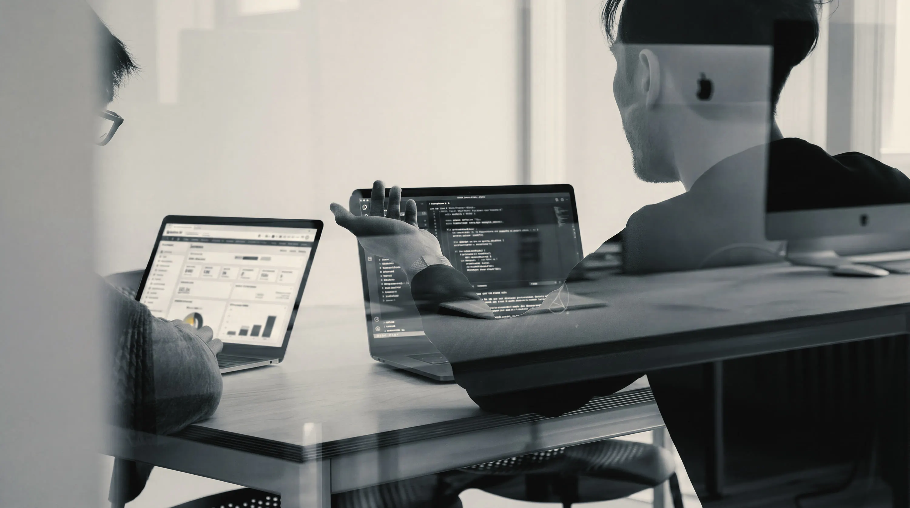 Laptops and monitors on a desk during an integration working session