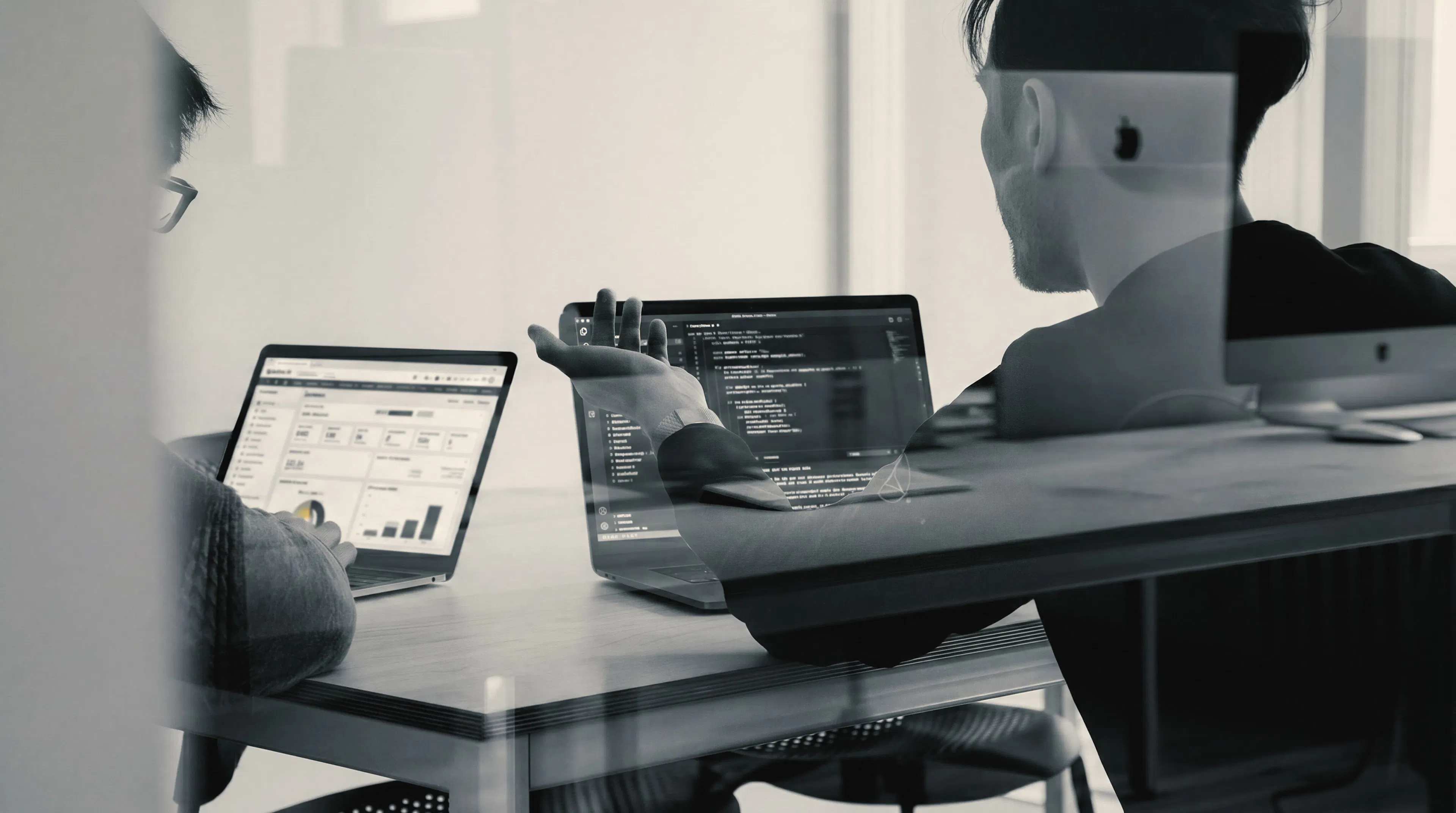 Laptops and monitors on a desk during an integration working session
