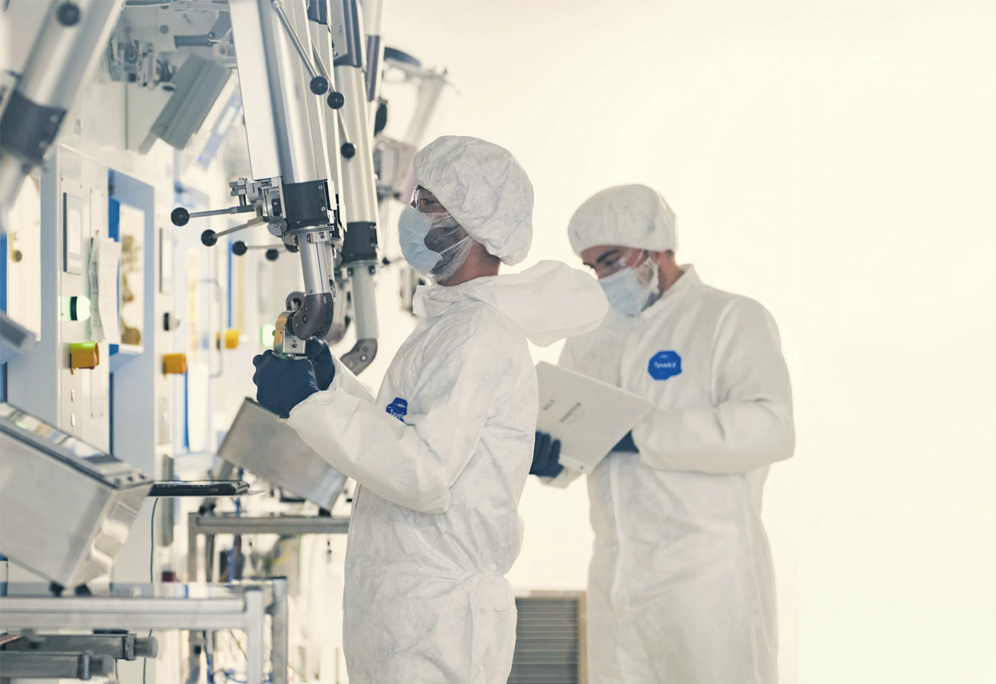 Technicians in cleanroom suits working in a sterile production area — SHINE Medical