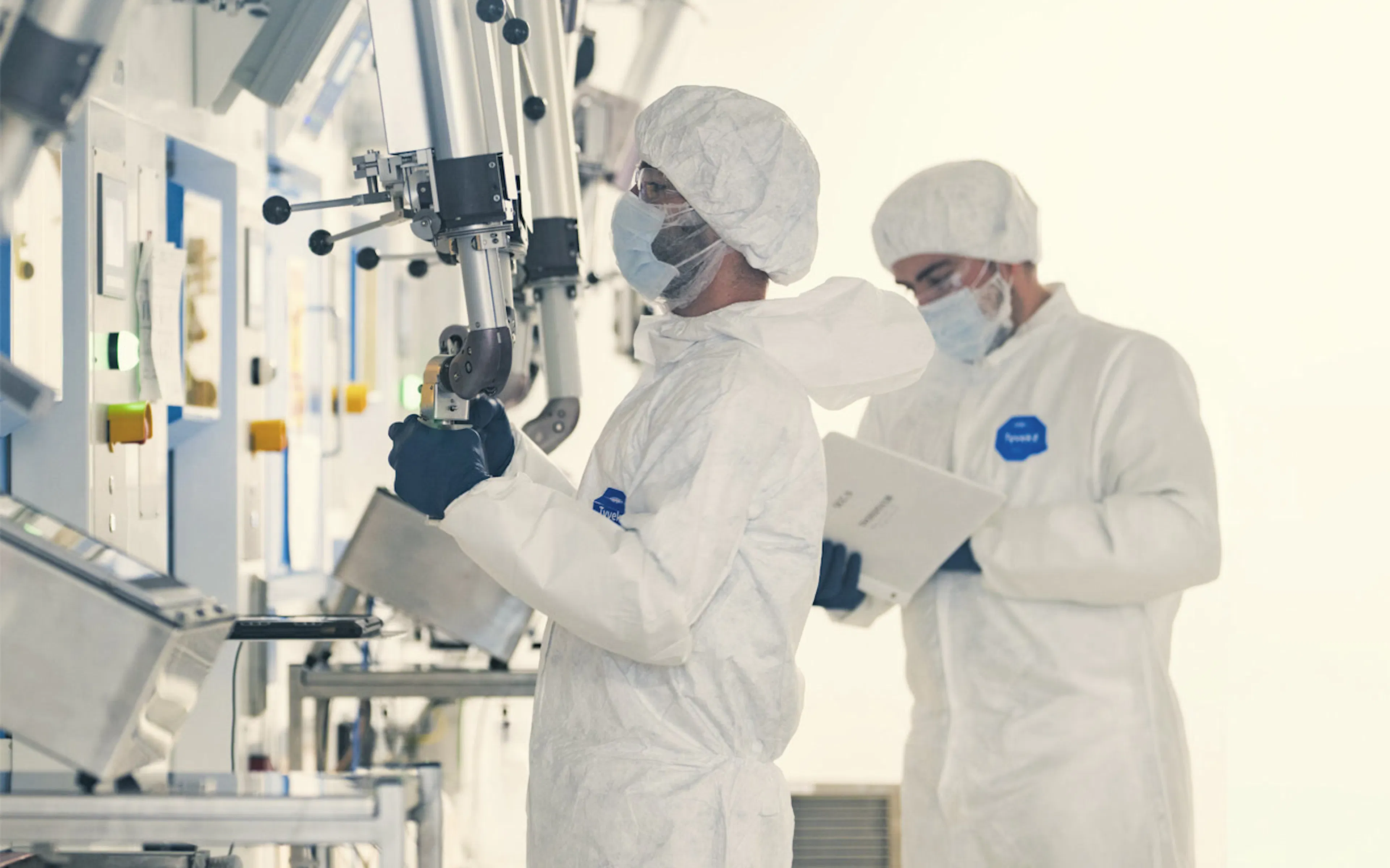 Technicians in cleanroom suits working in a sterile production area — SHINE Medical