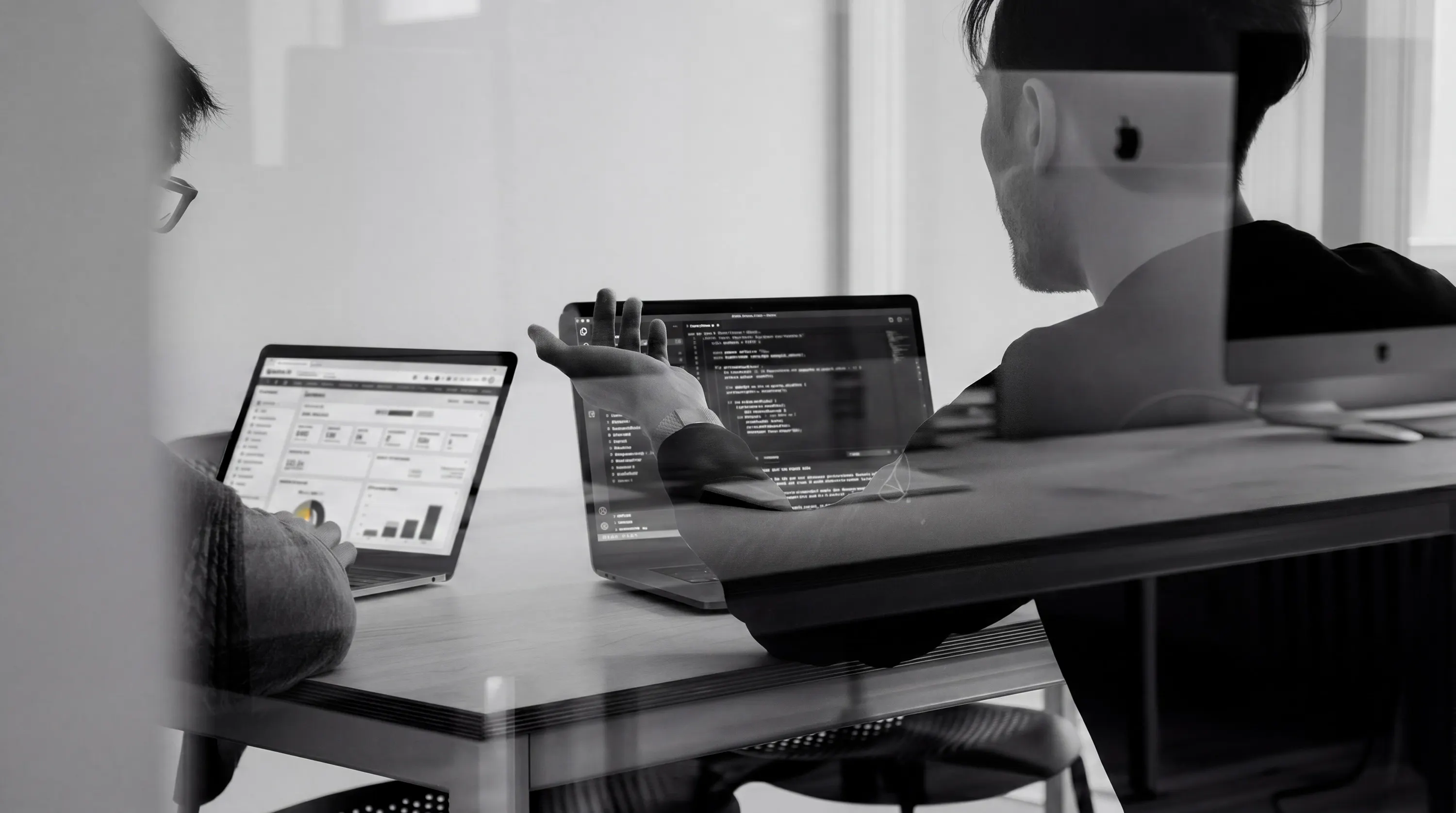 Laptops and notes on a desk during a NetSuite implementation working session